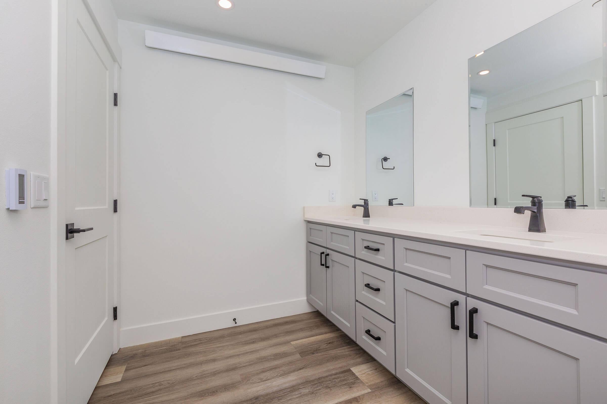 a kitchen with a sink and a mirror