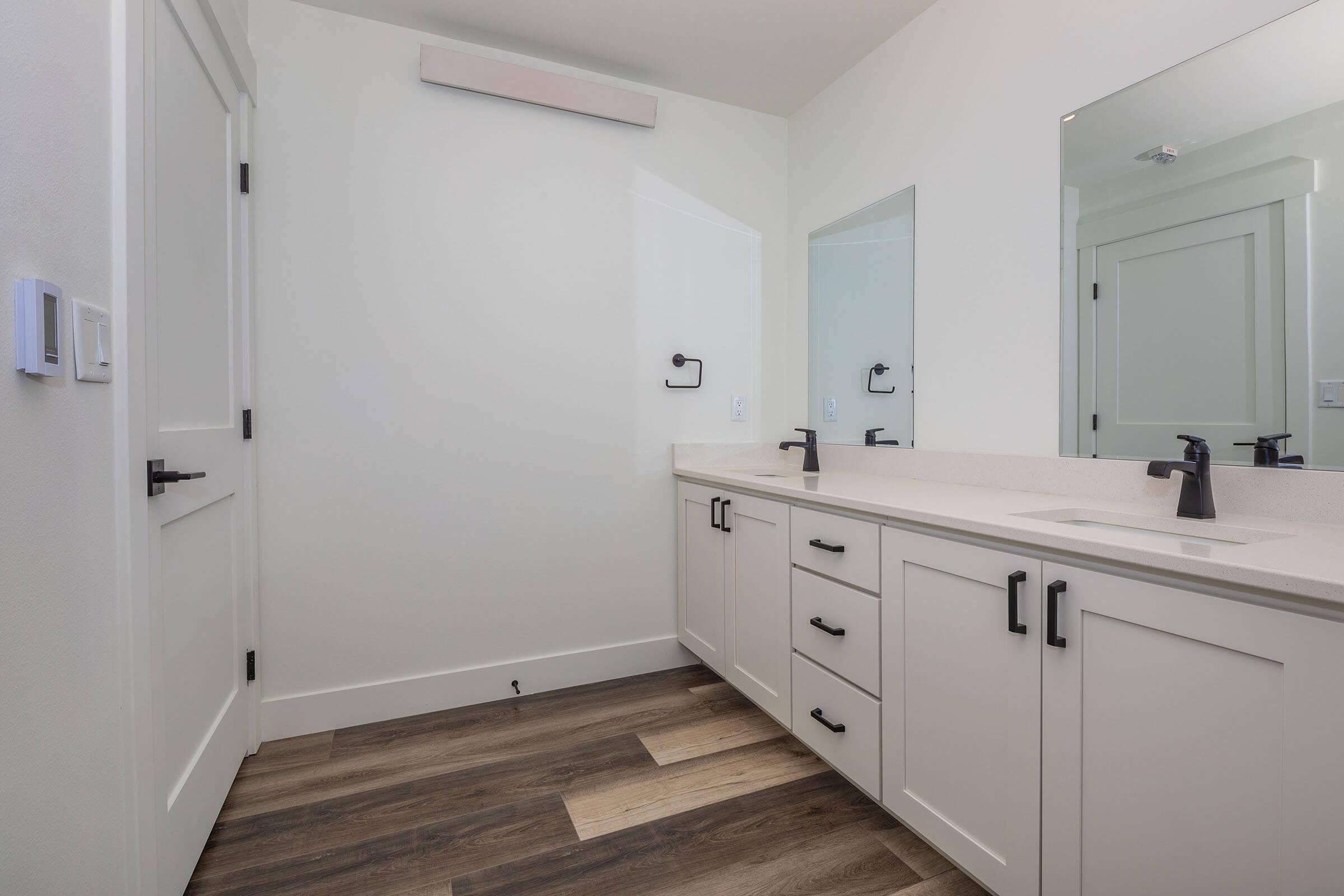 a kitchen with a sink and a mirror