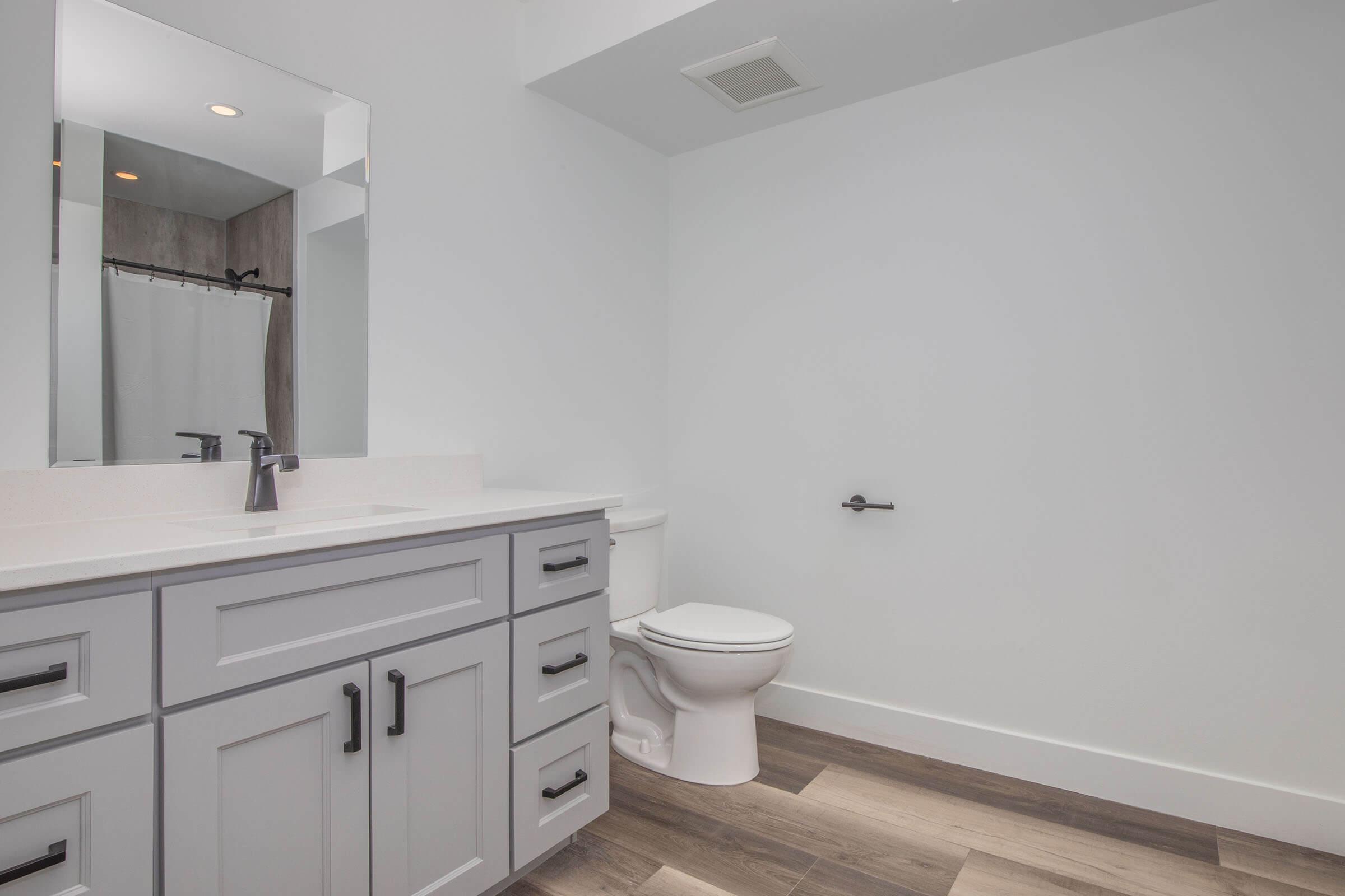 a kitchen with a sink and a mirror