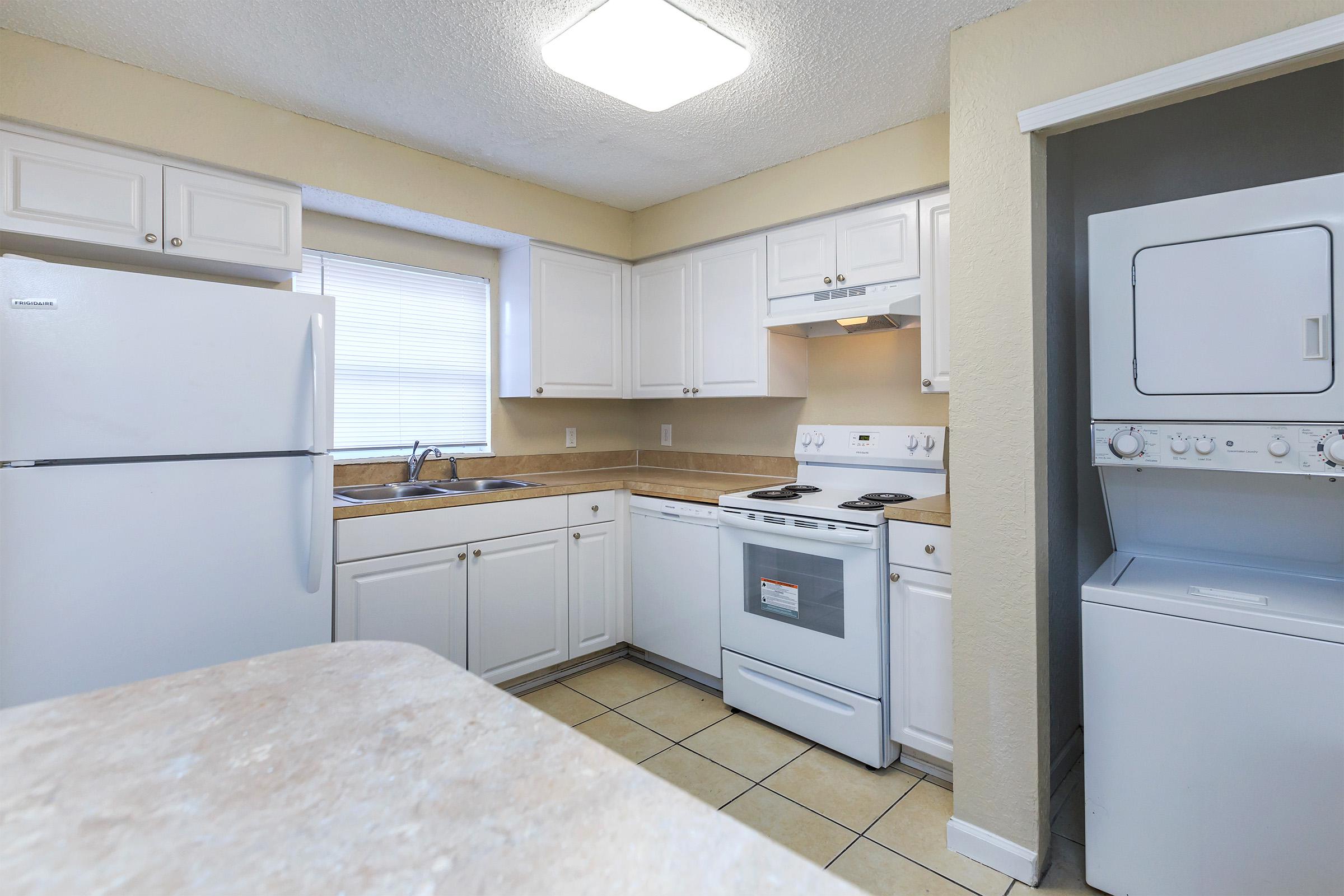 a large white refrigerator in a kitchen