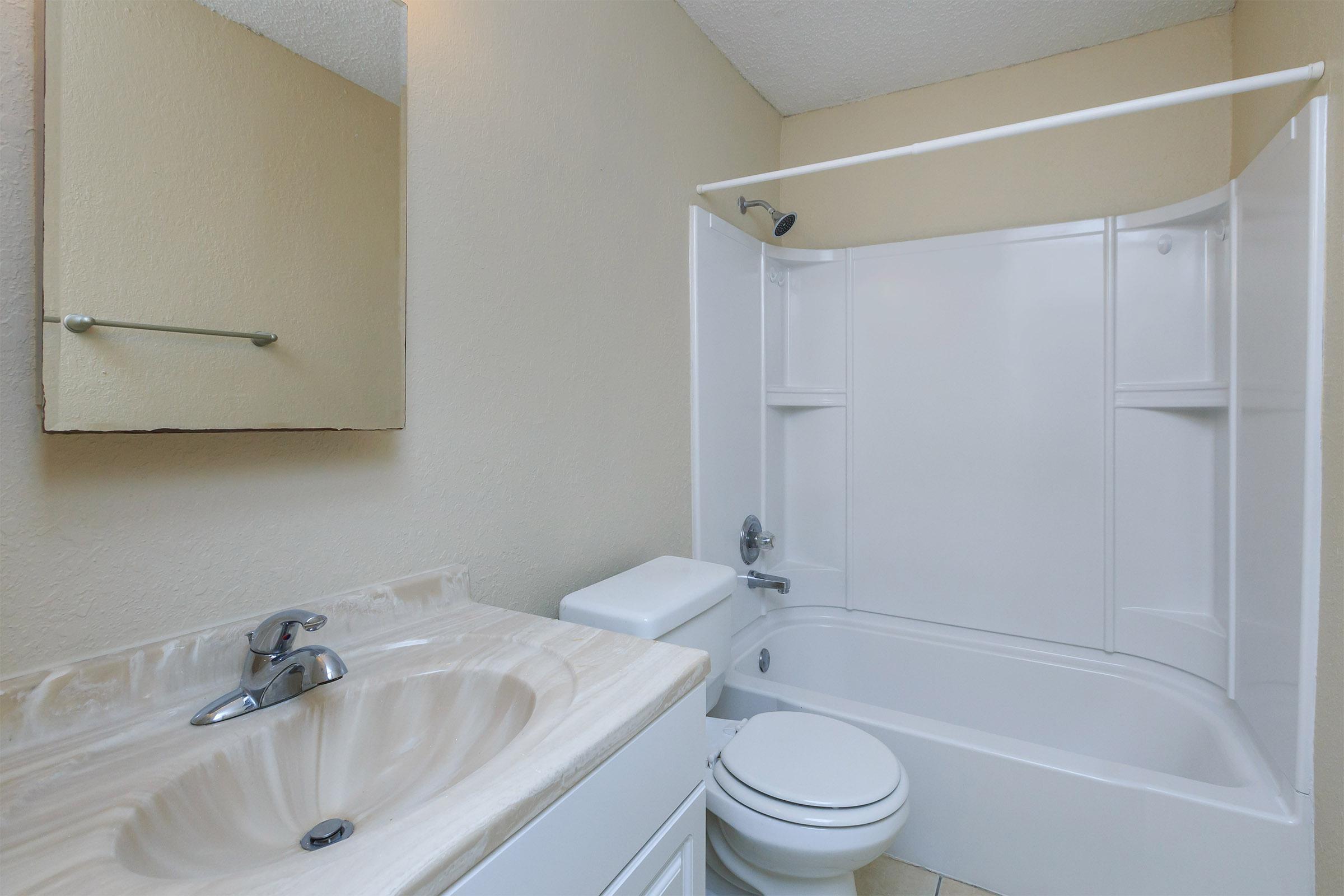 a white tub sitting next to a sink