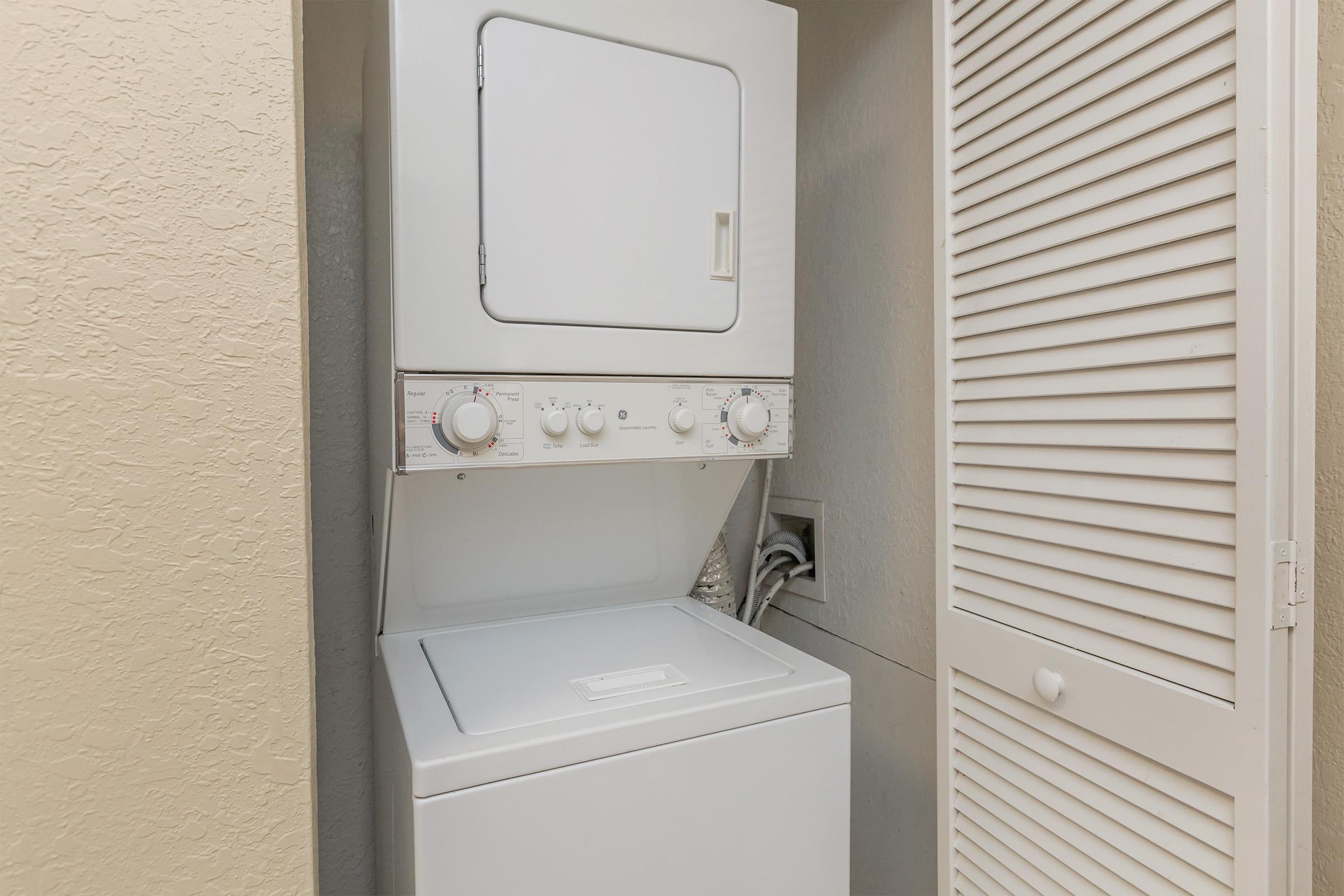 a white refrigerator freezer sitting next to a window