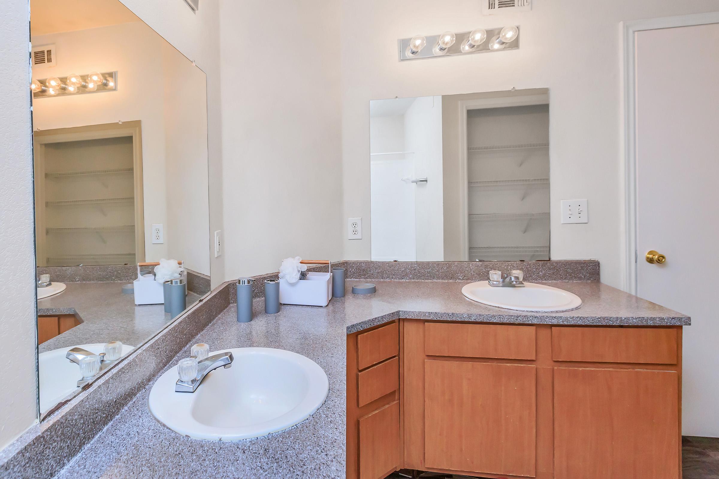 a kitchen with a sink and a mirror
