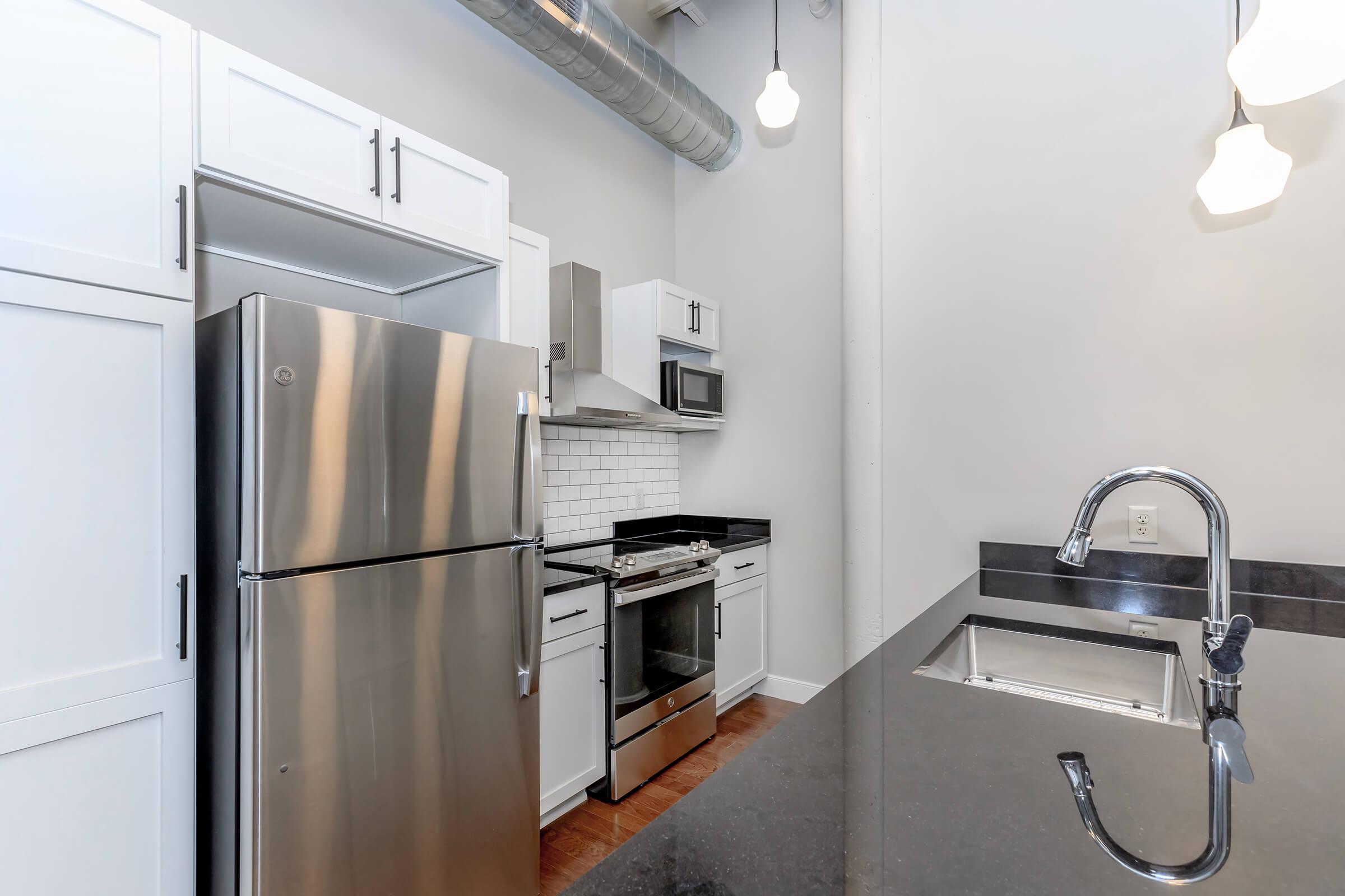 a kitchen with a sink and a refrigerator