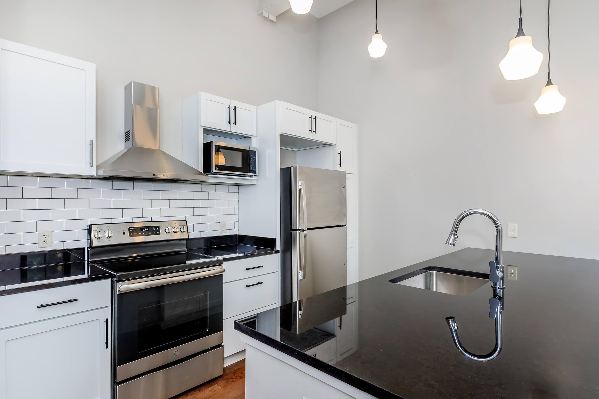 a kitchen with a sink and a mirror