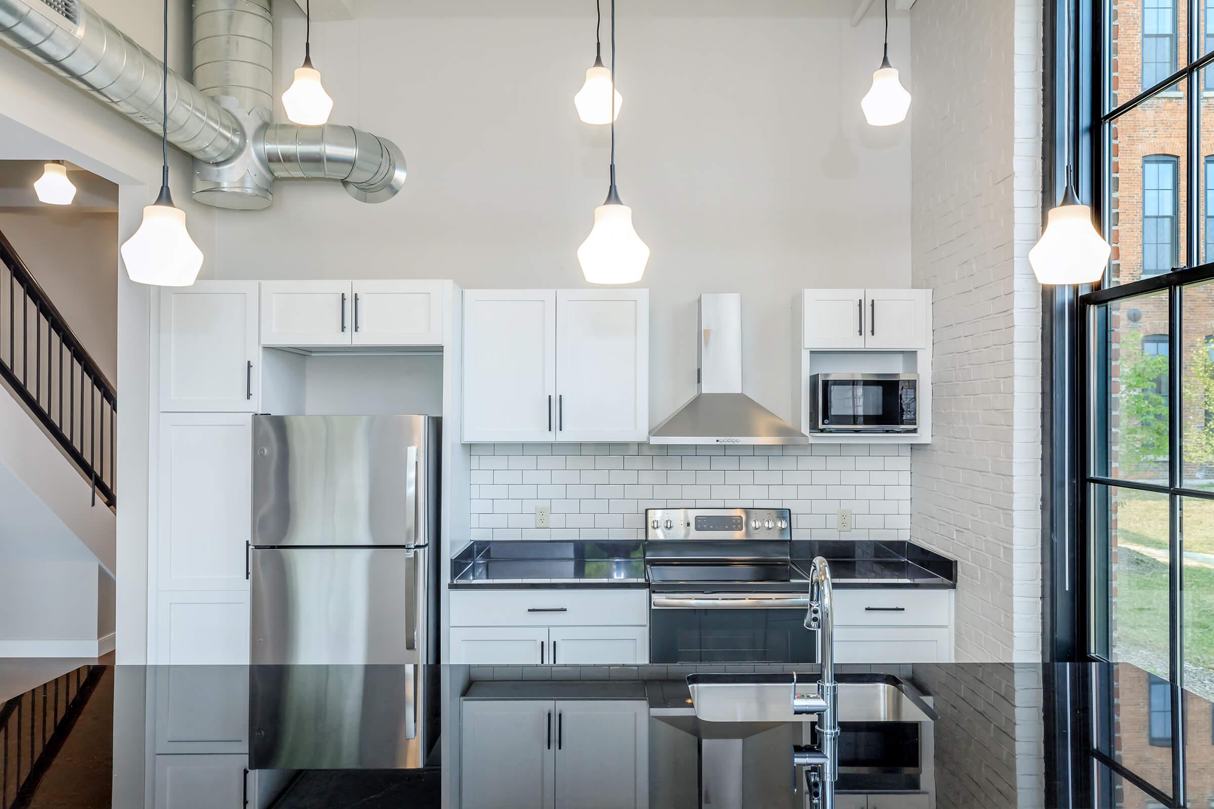 a kitchen with a stove top oven sitting inside of a room