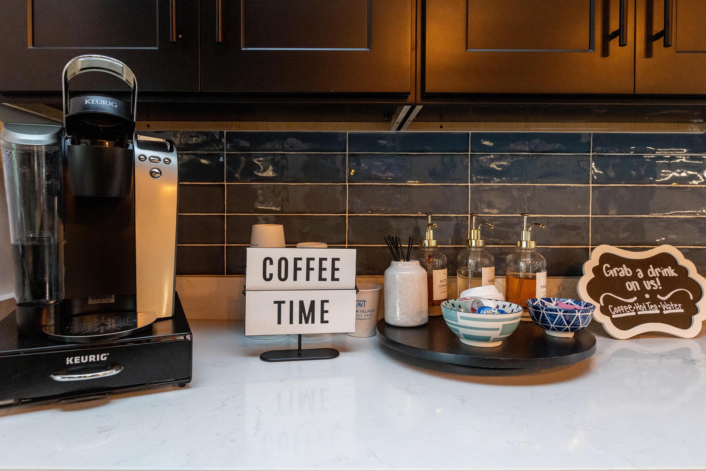 a kitchen counter with a stack of flyers on a table