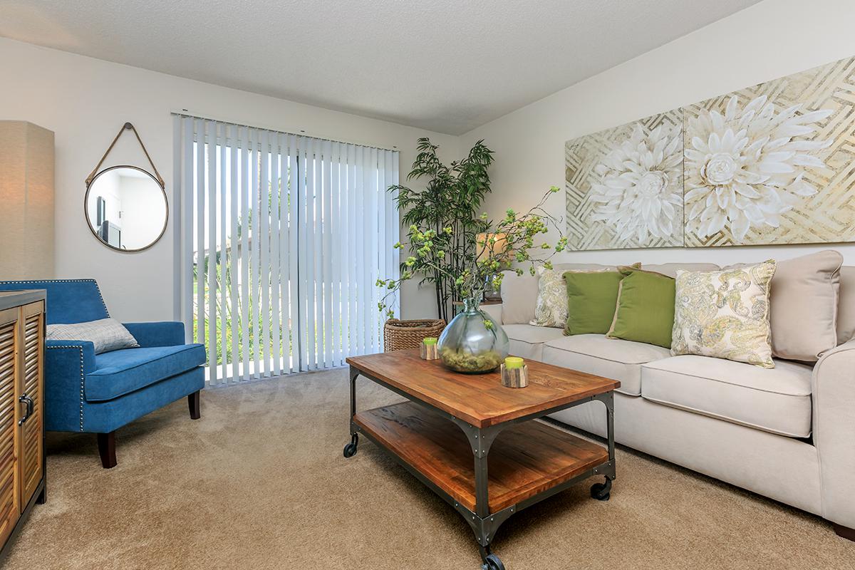 a living room filled with furniture and a flat screen tv