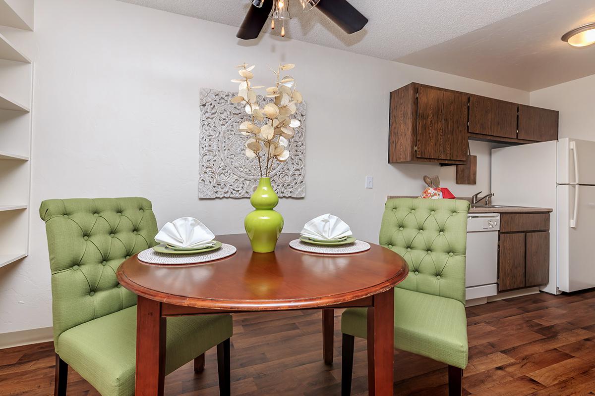 a living room filled with furniture and vase on a table