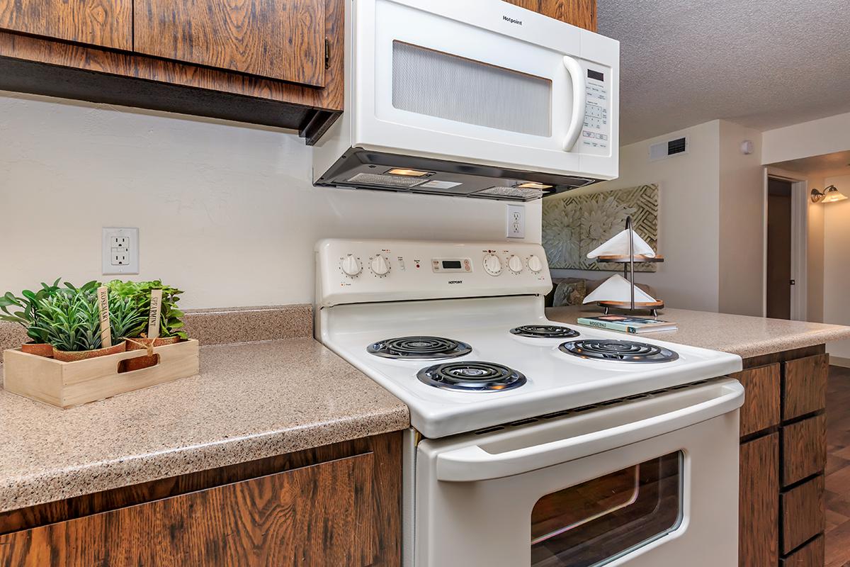 a white stove top oven sitting inside of a kitchen