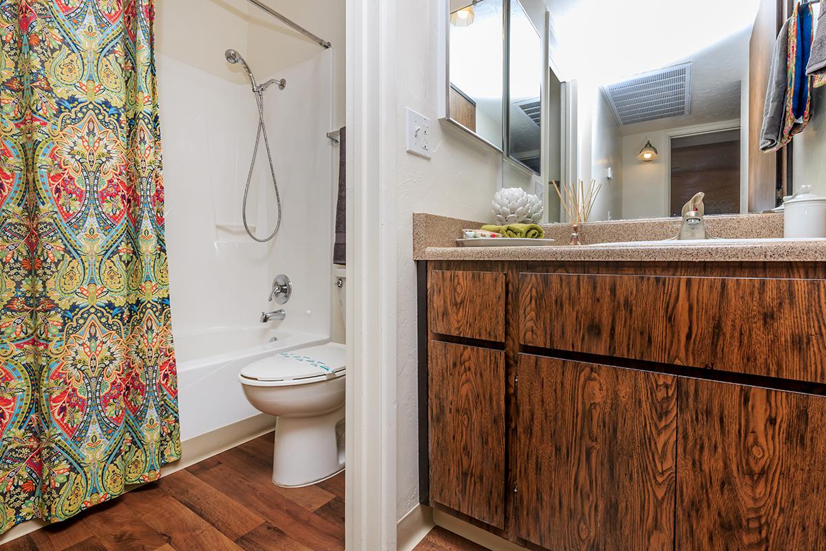 a white tub sitting next to a shower