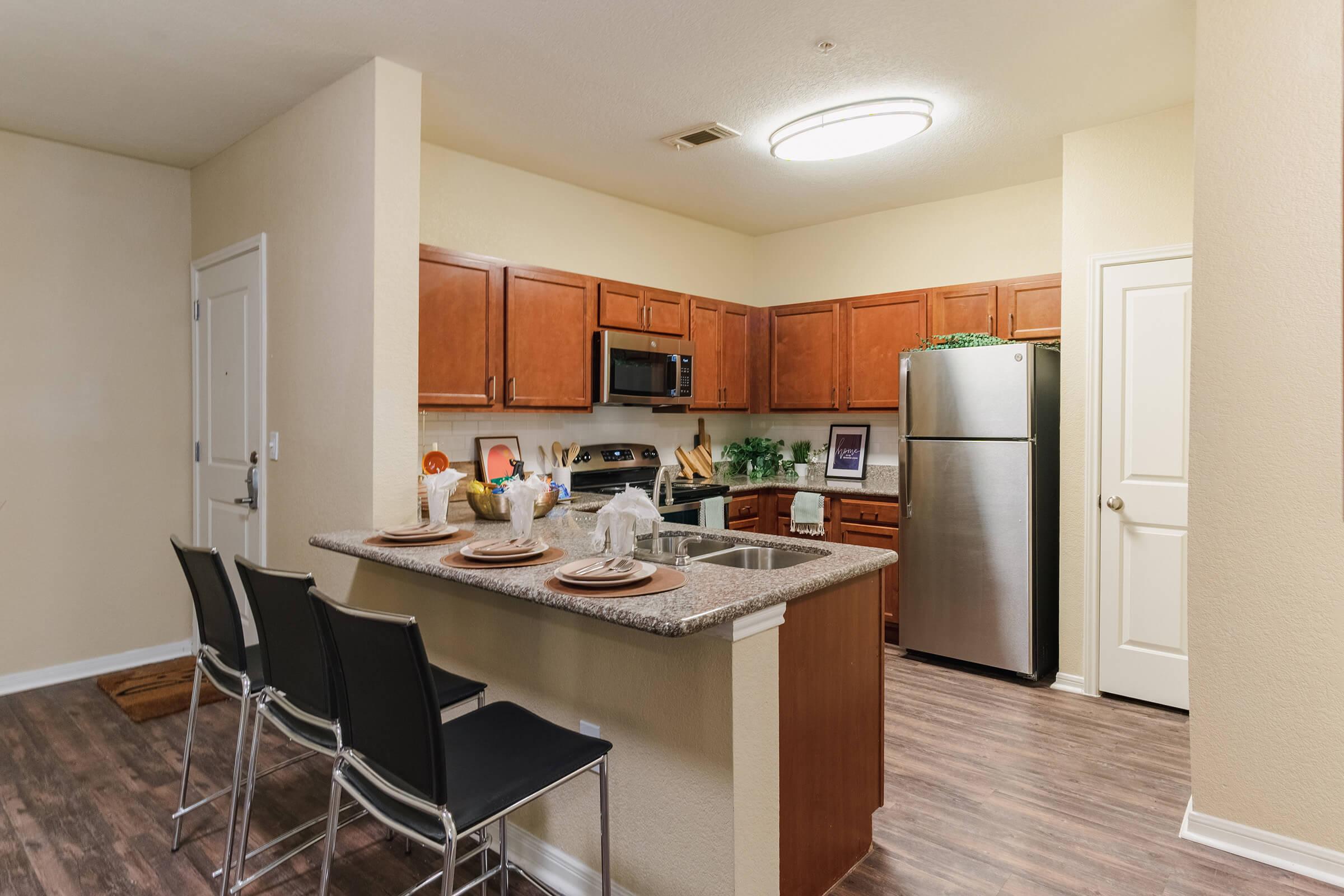 a kitchen with a stove and a refrigerator