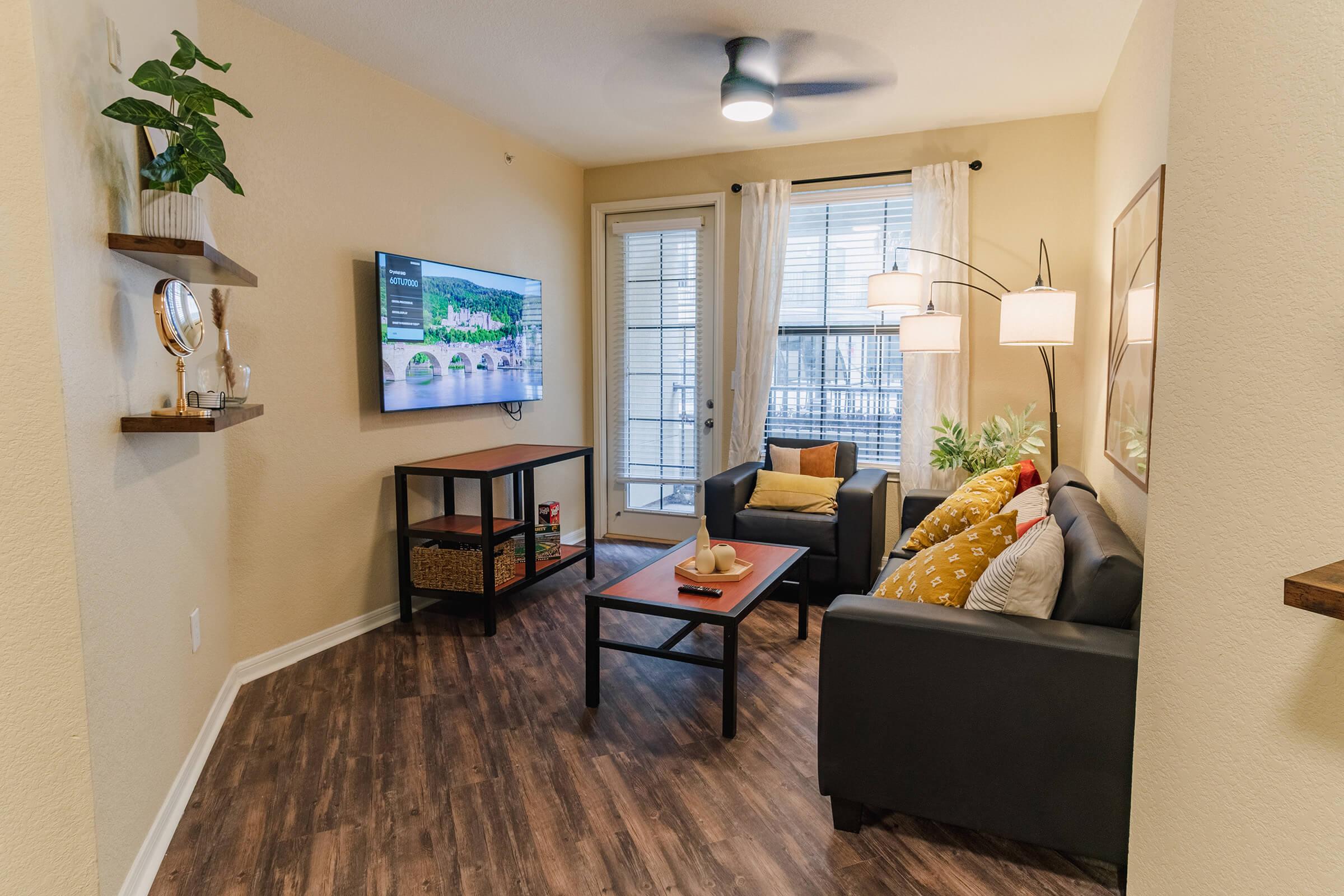 a living room filled with furniture and a large window