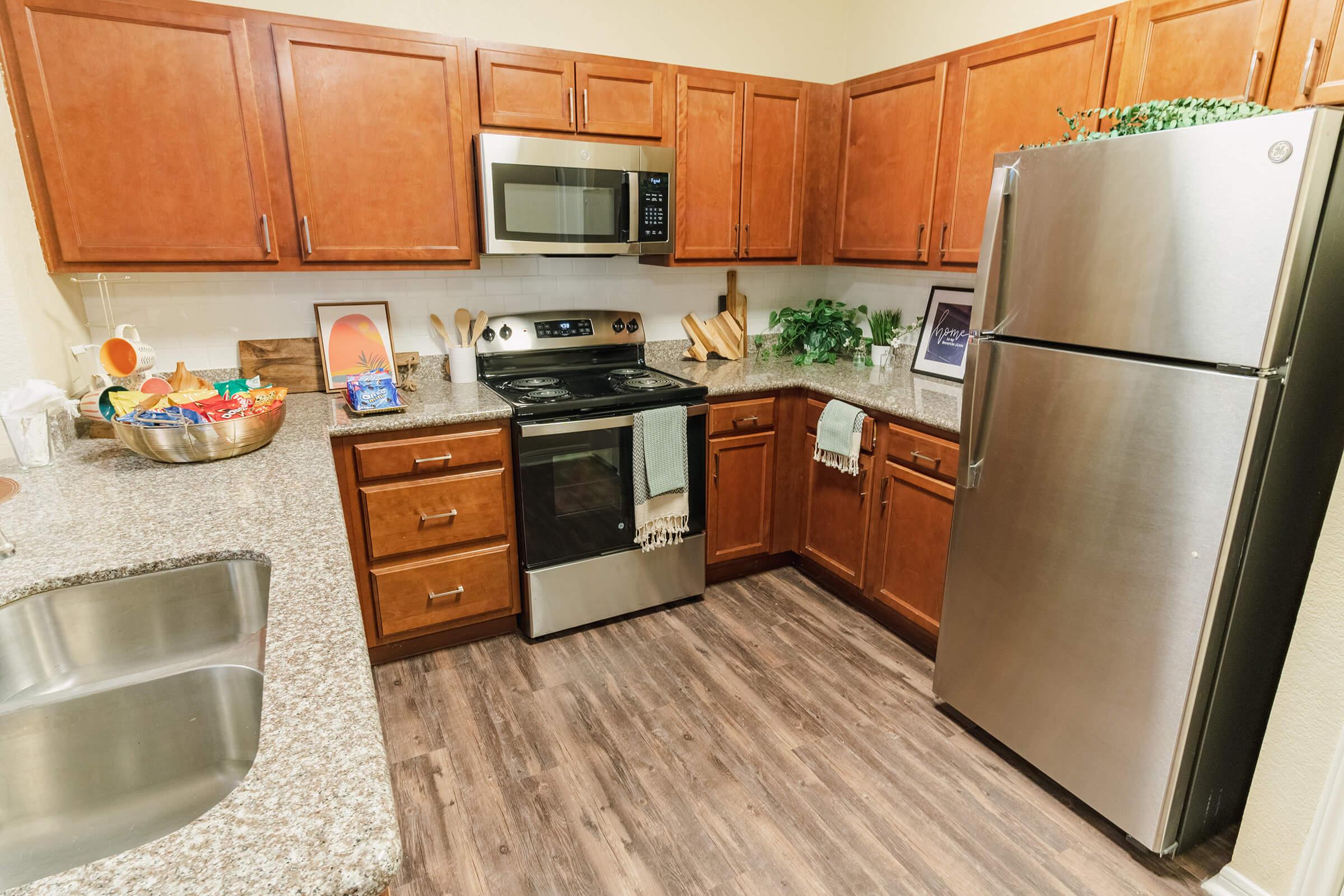 a kitchen with stainless steel appliances and wooden cabinets