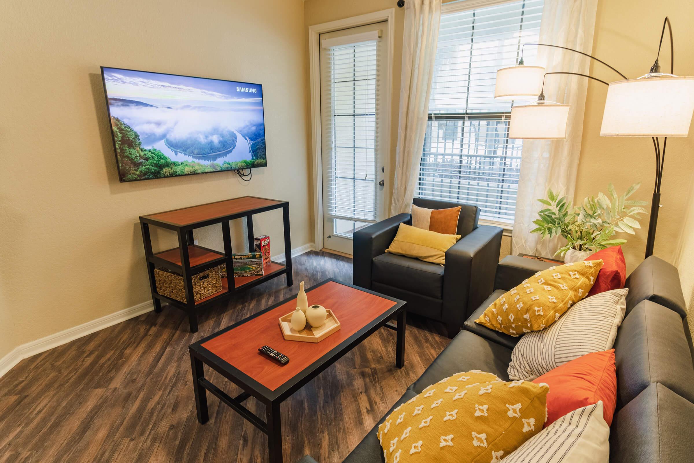 a living room filled with furniture and a window