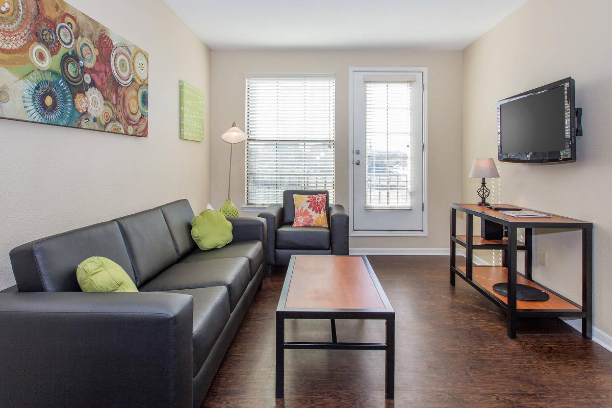 a living room filled with furniture and a large window