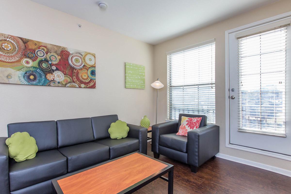 a living room filled with furniture and a large window