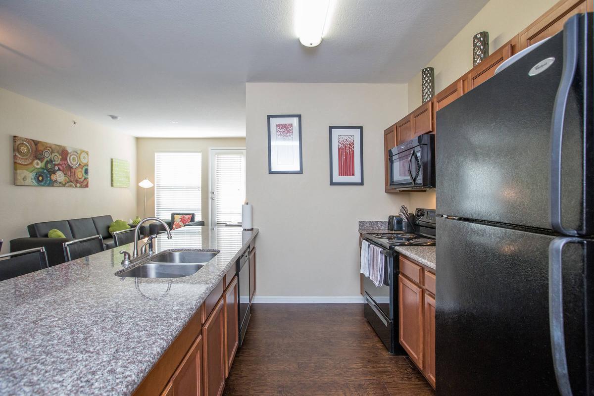 a kitchen with a stainless steel refrigerator in a room