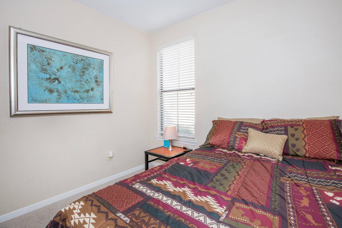 a bedroom with a red rug