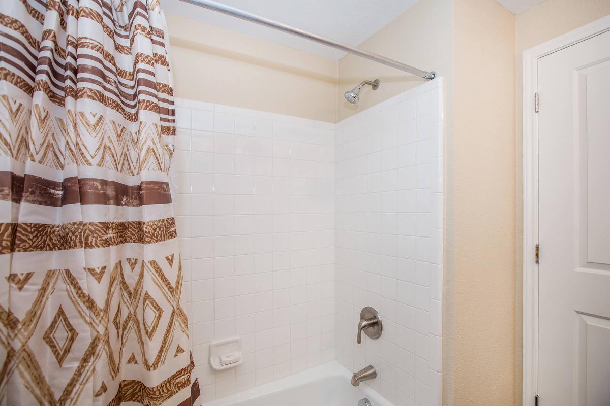 a white sink sitting under a mirror