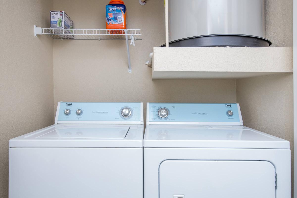 a white microwave oven sitting on top of a refrigerator