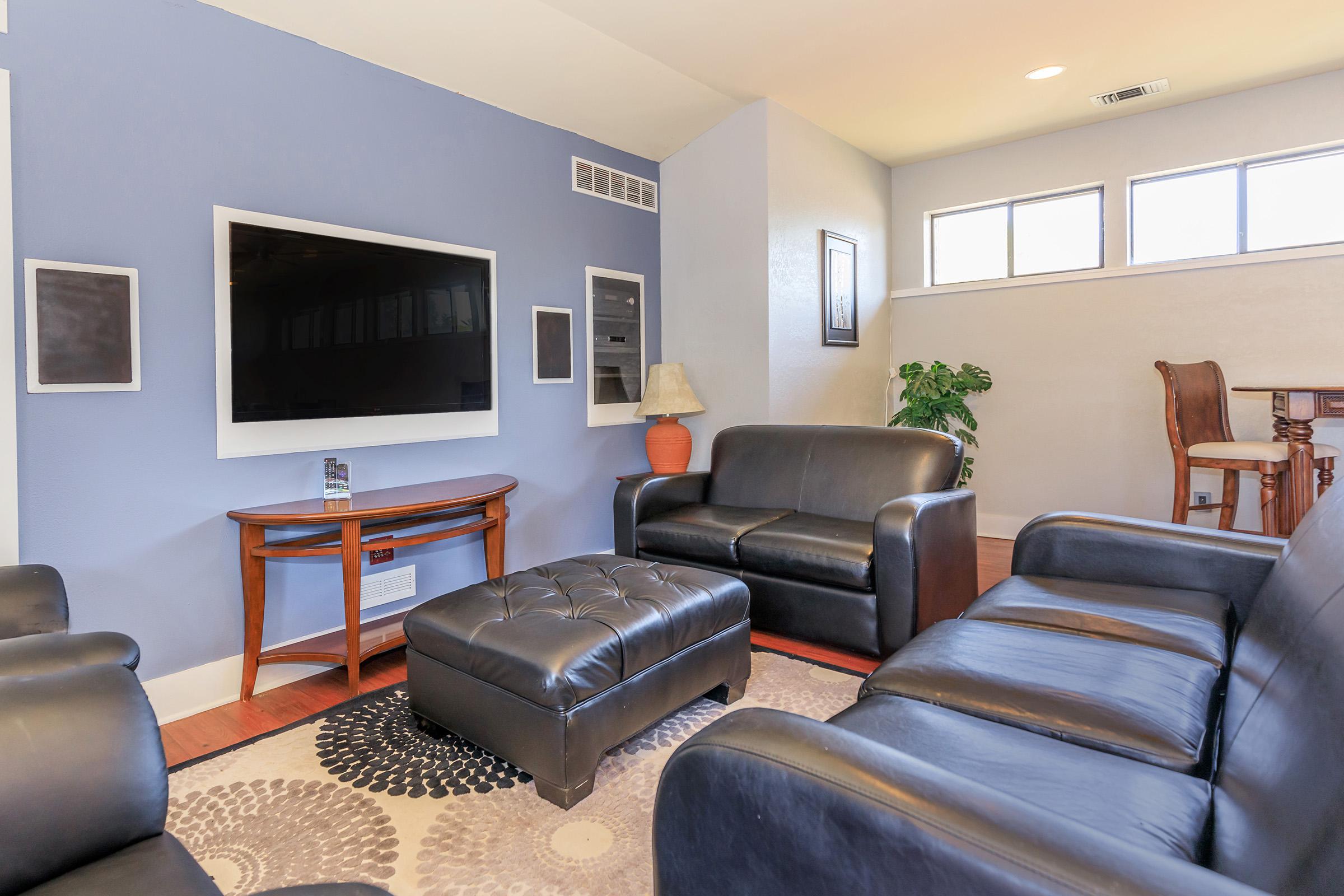 a living room filled with furniture and a large window