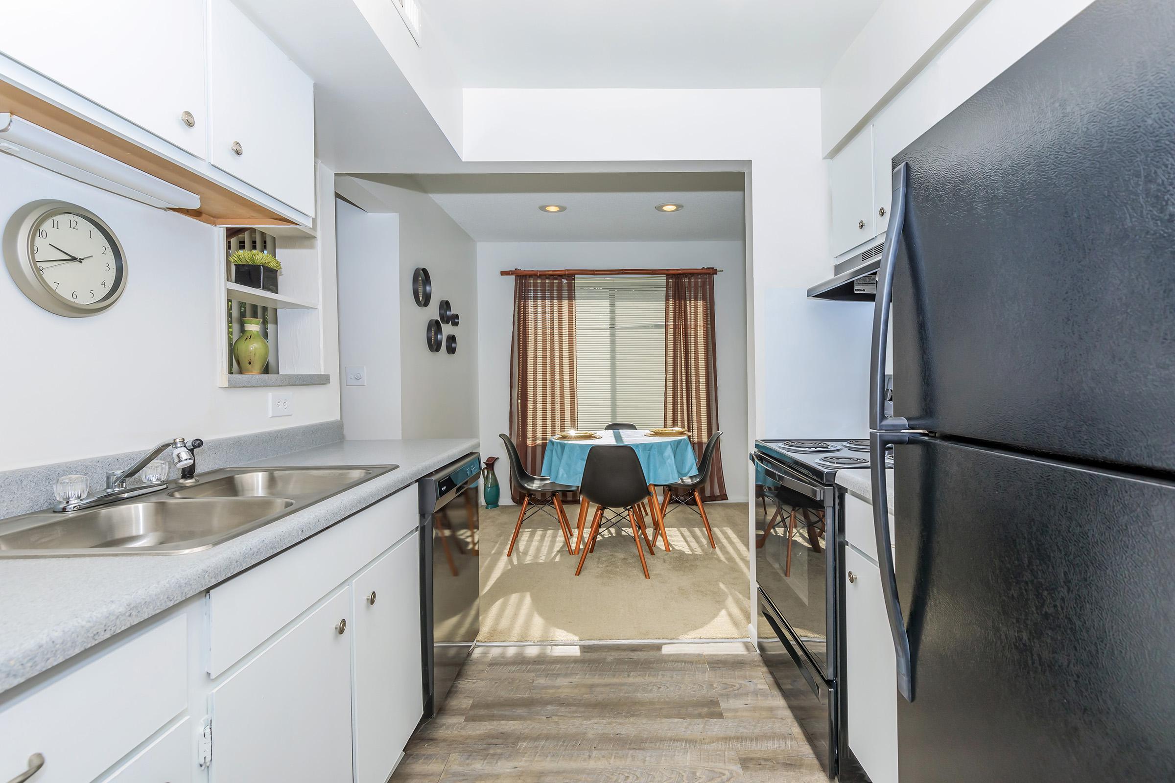 a kitchen with a stove top oven sitting inside of a room