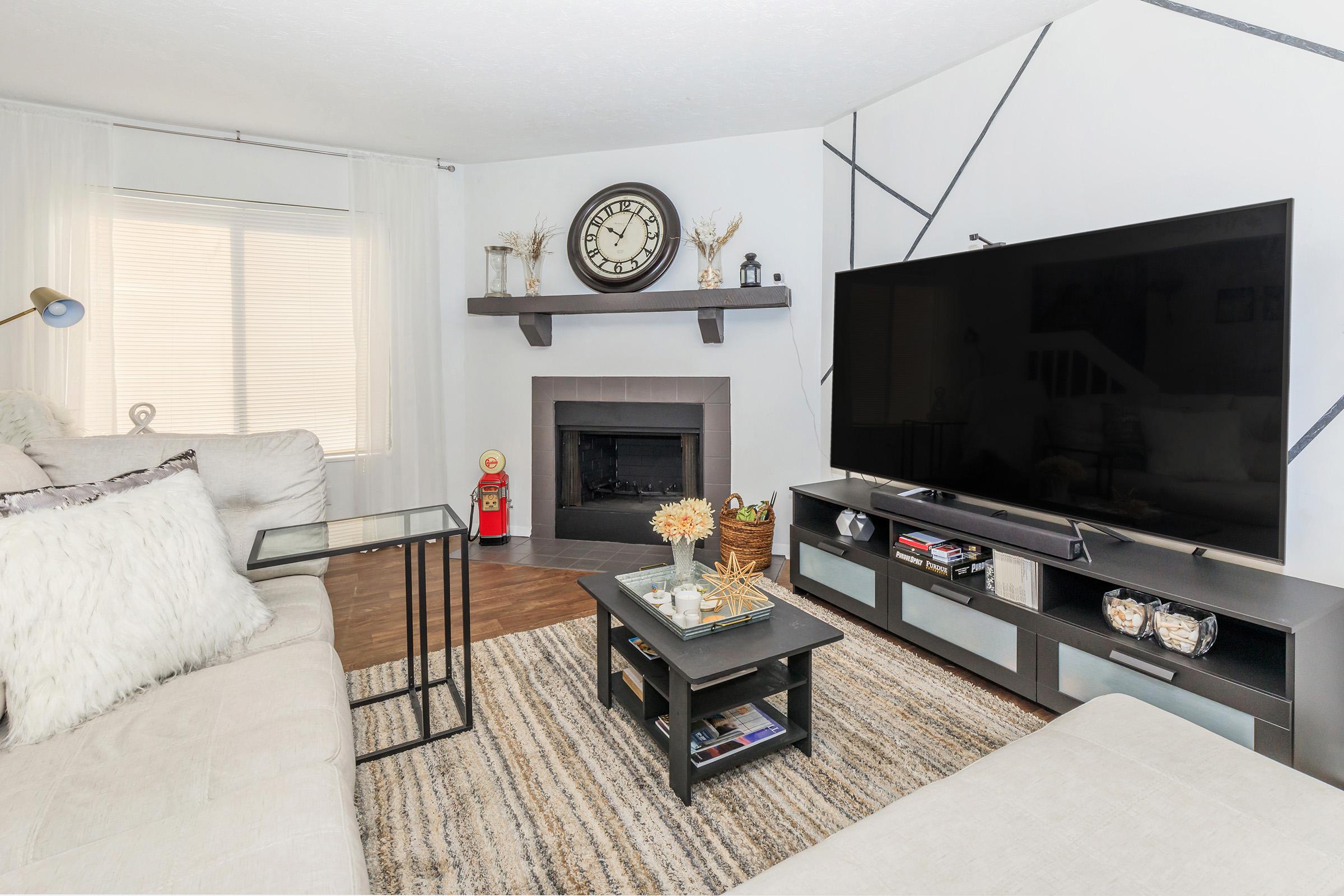 a living room filled with furniture and a flat screen tv