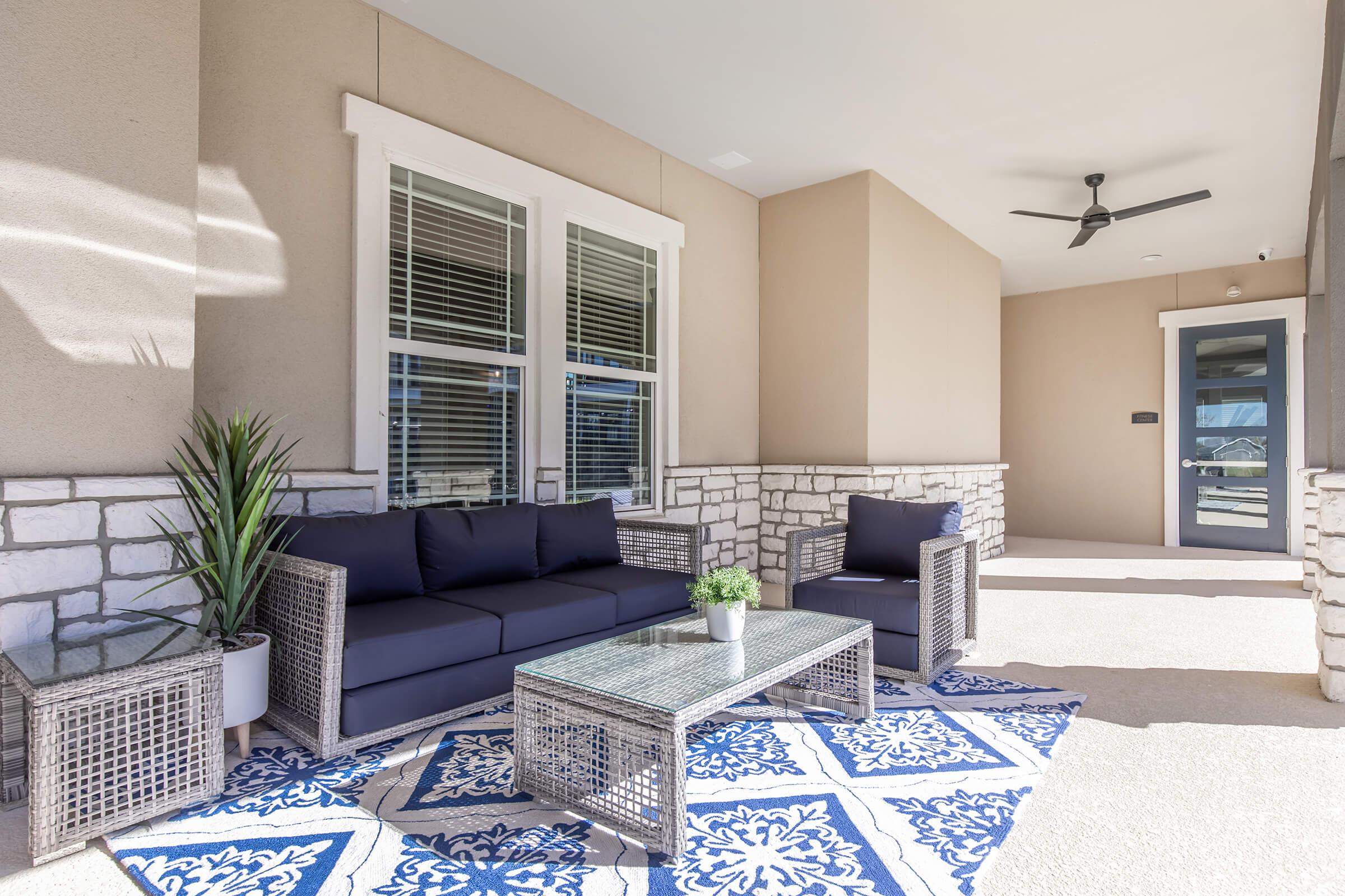 a living room filled with furniture and a large window