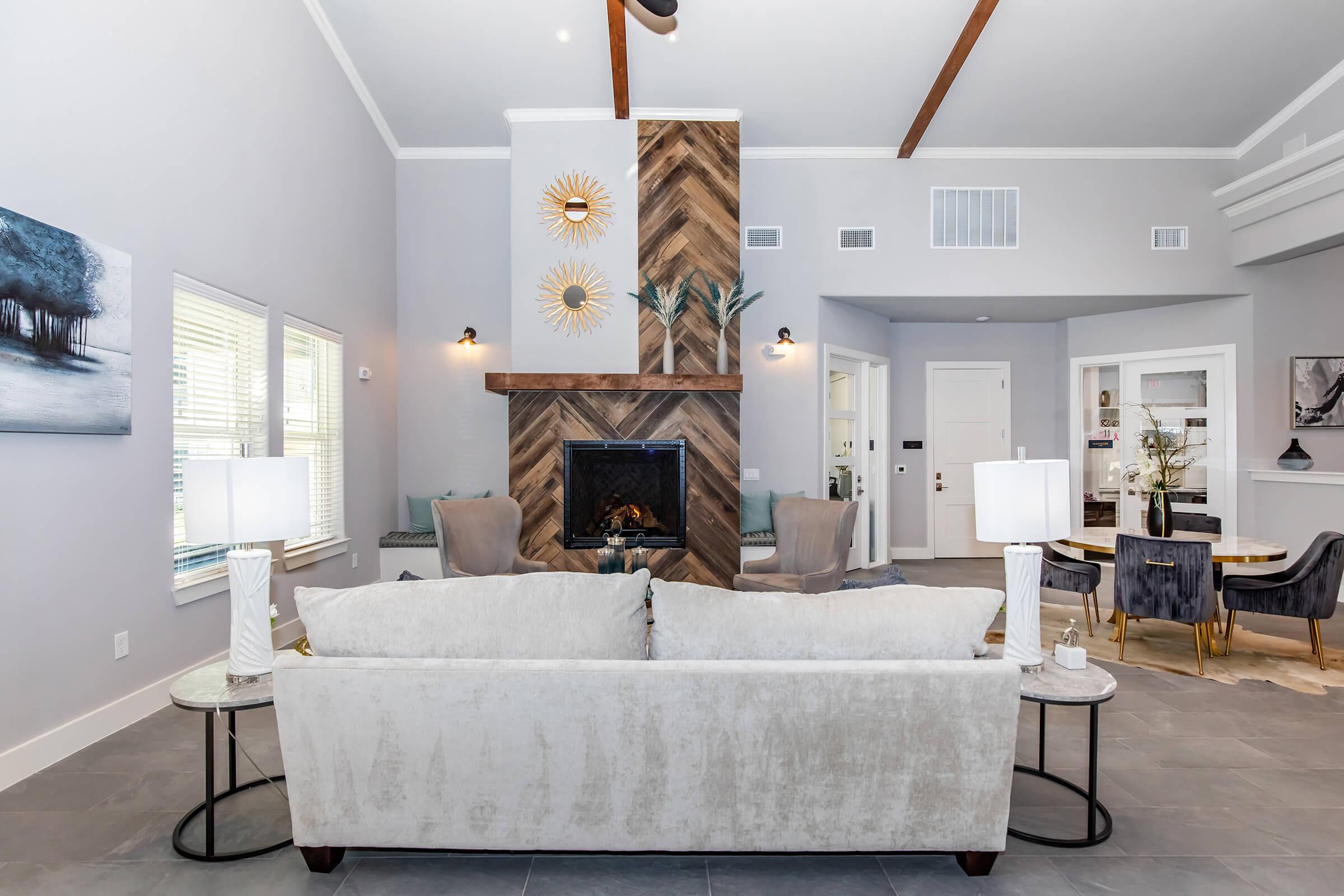 a living room filled with furniture and a fireplace