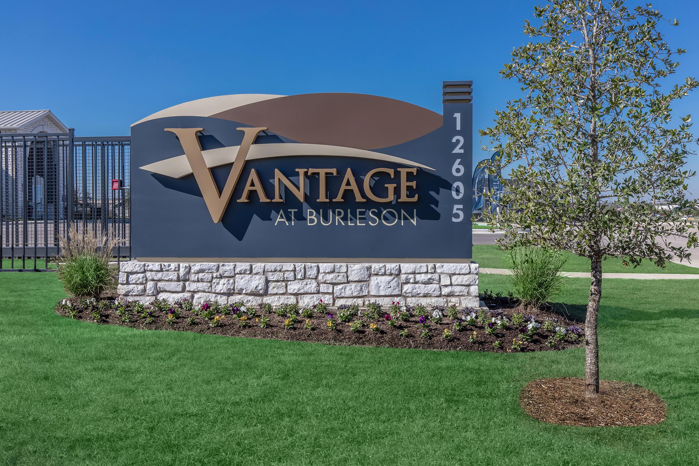 a large lawn in front of a sign