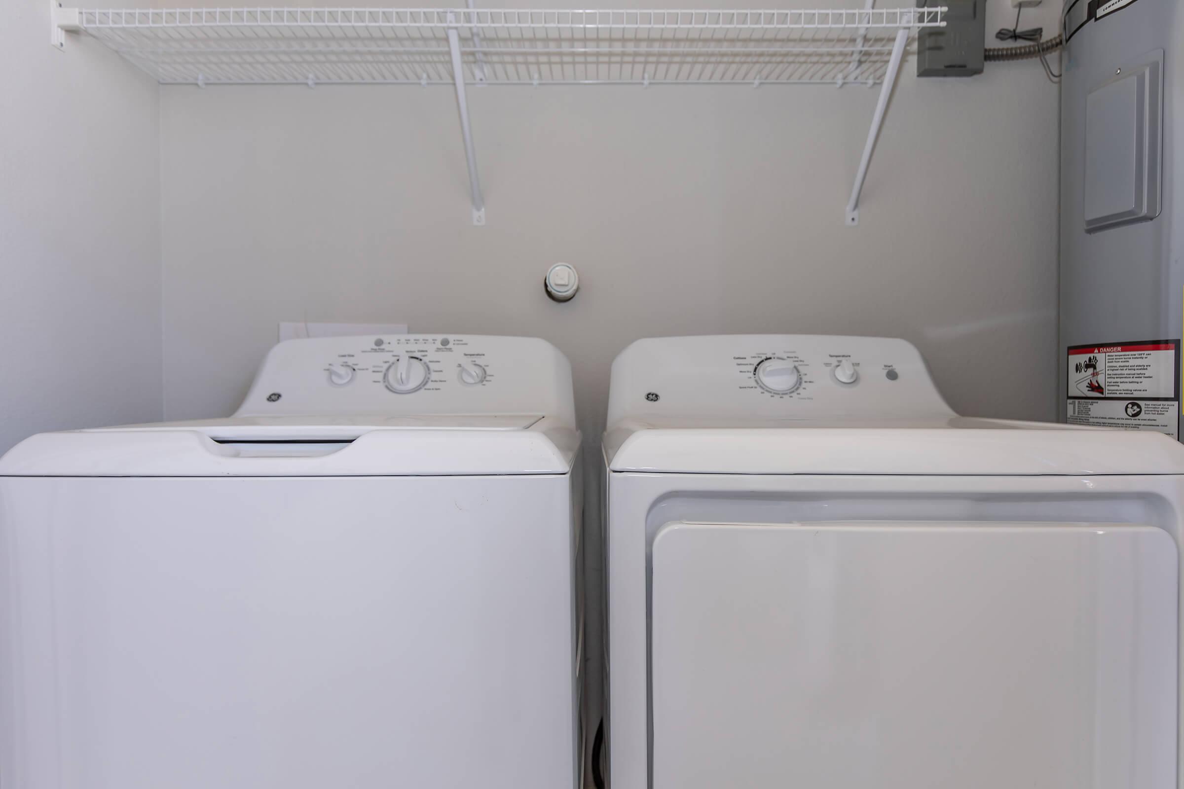 a microwave oven sitting on top of a refrigerator