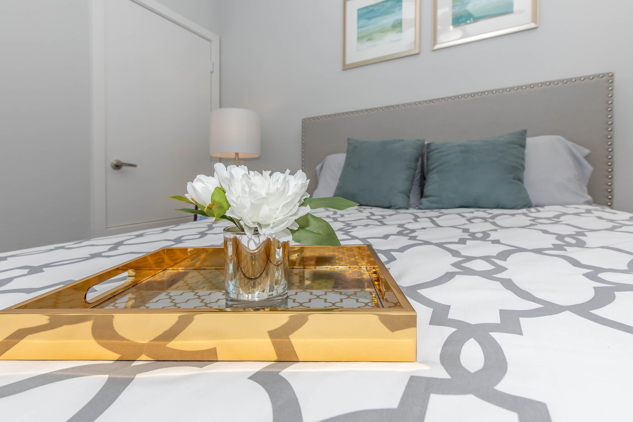 a table topped with plates of food on a bed