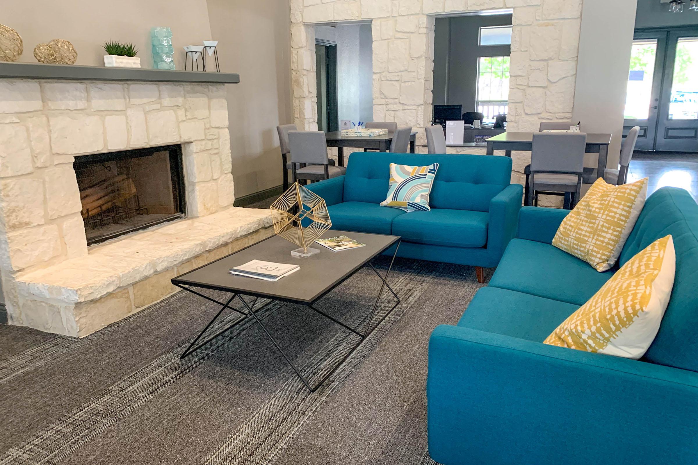 a living room filled with furniture and a fire place