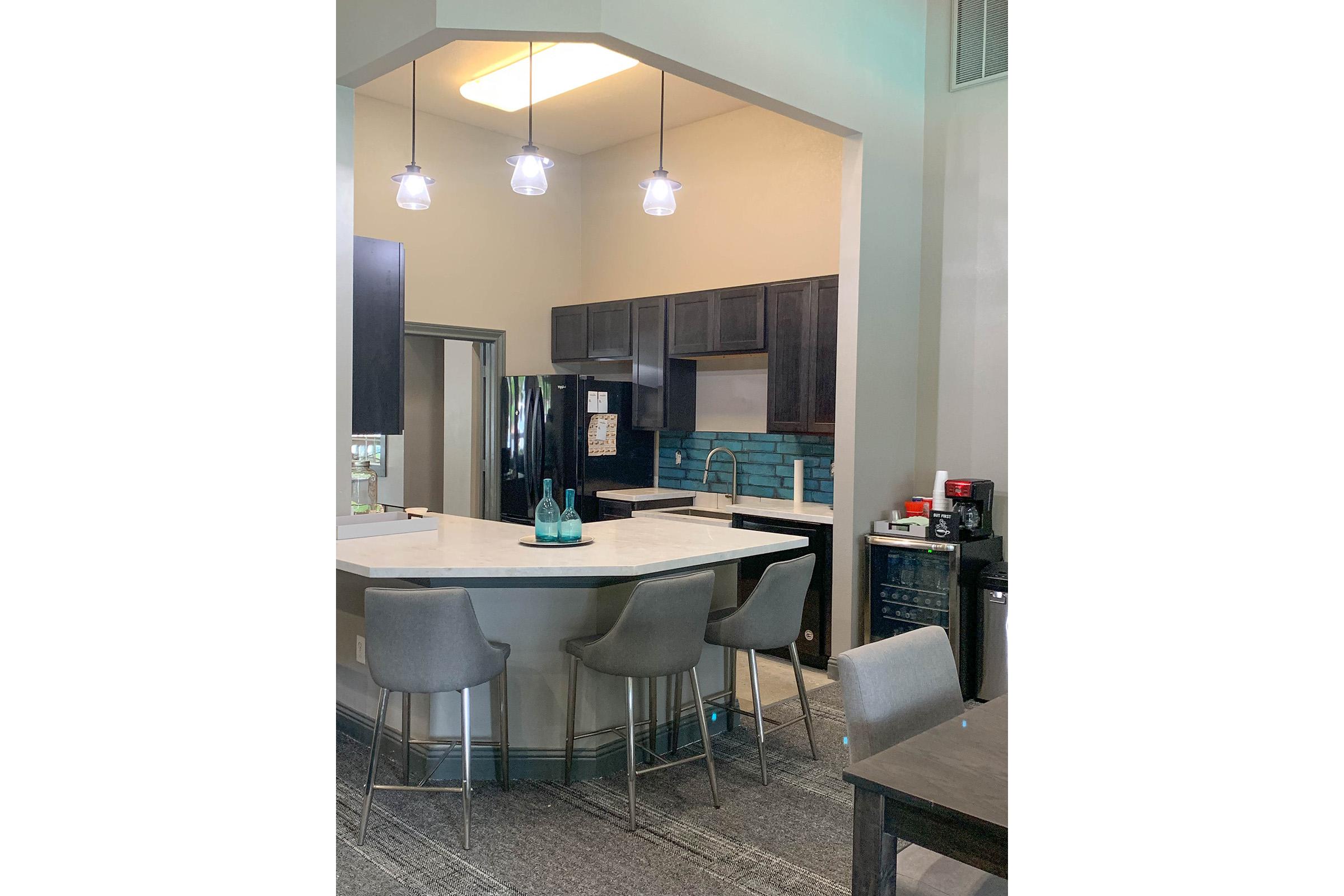 a kitchen with a sink and a mirror