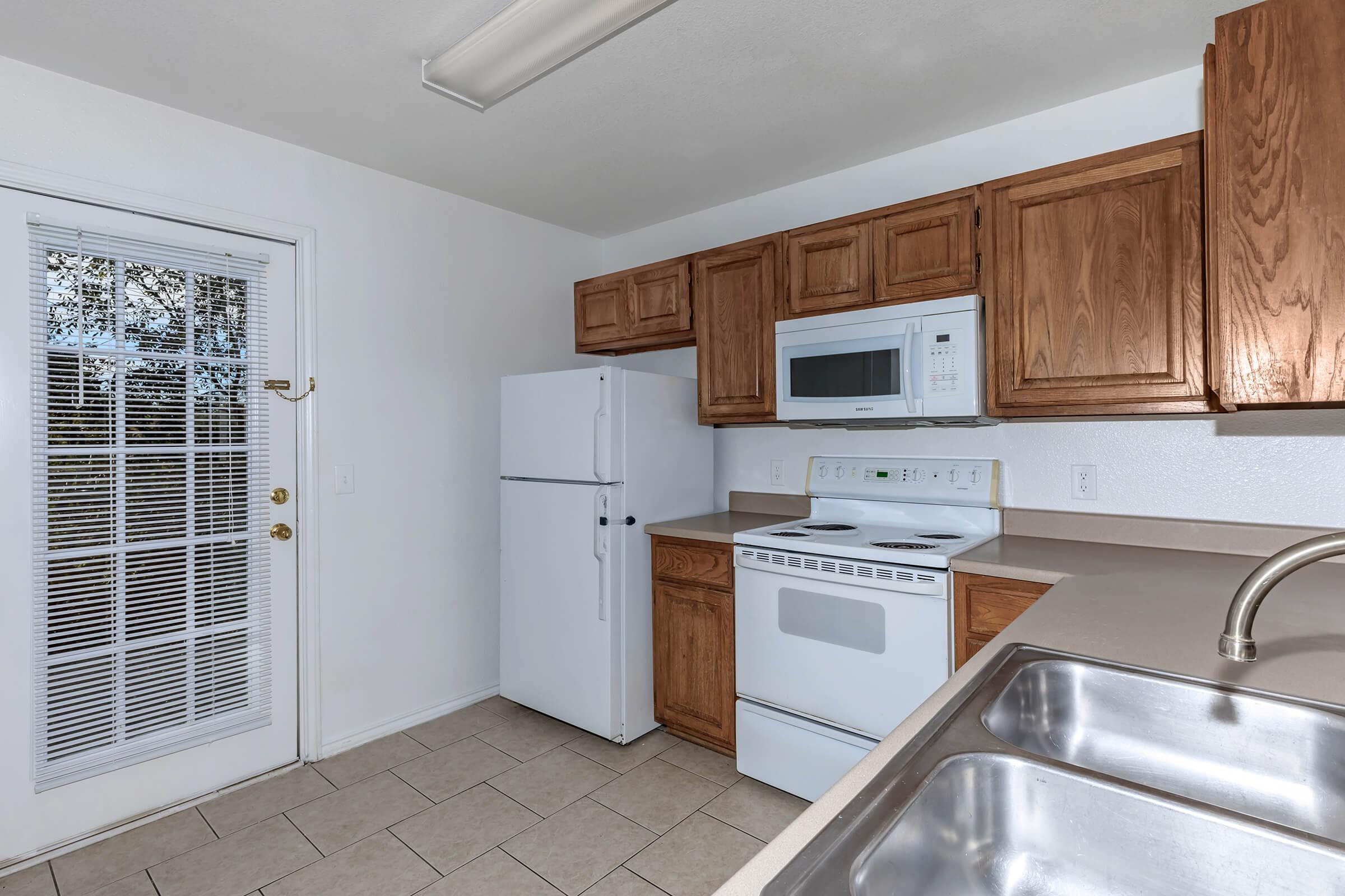 a kitchen with a stove and a refrigerator