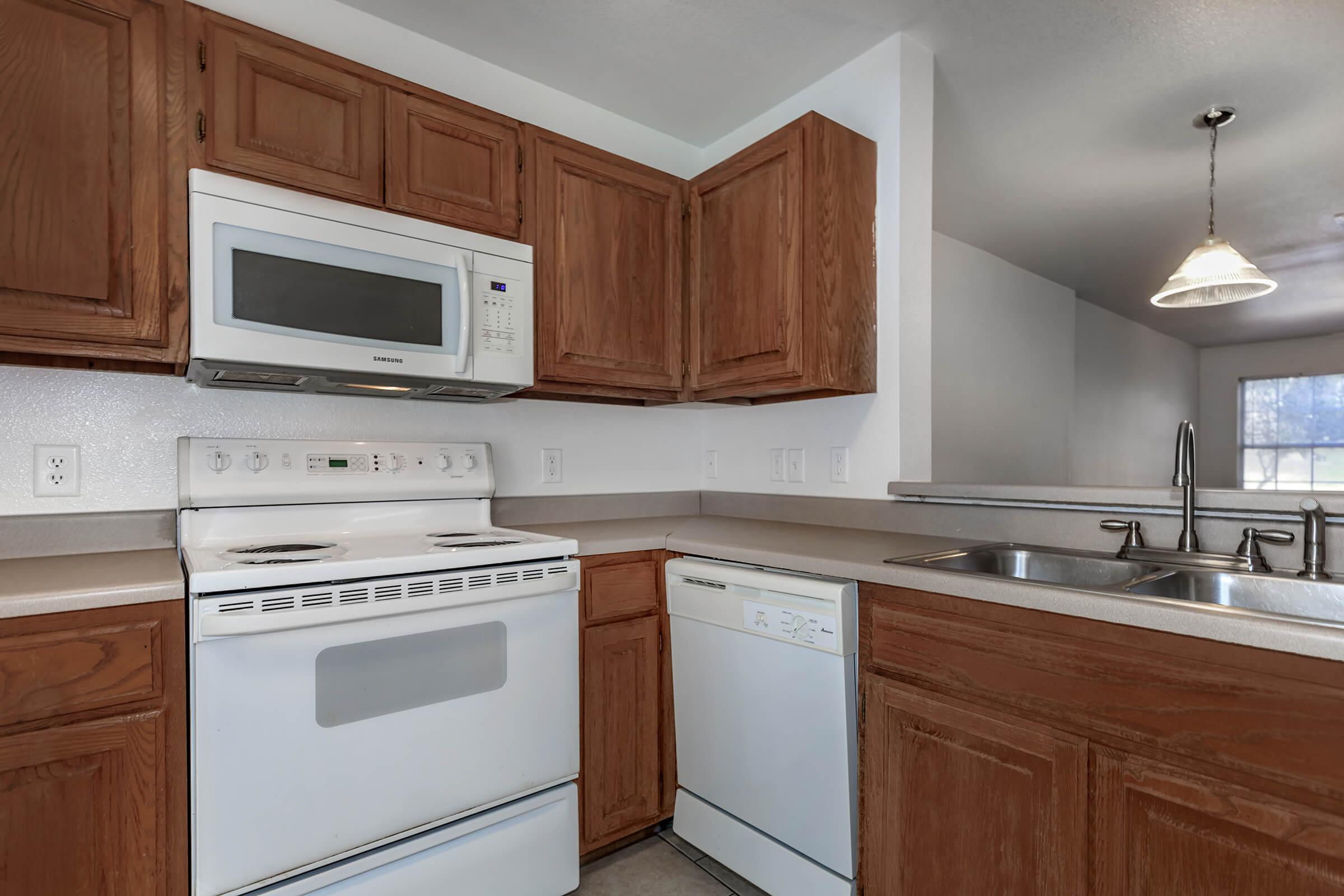 a kitchen with a stove a sink and a microwave