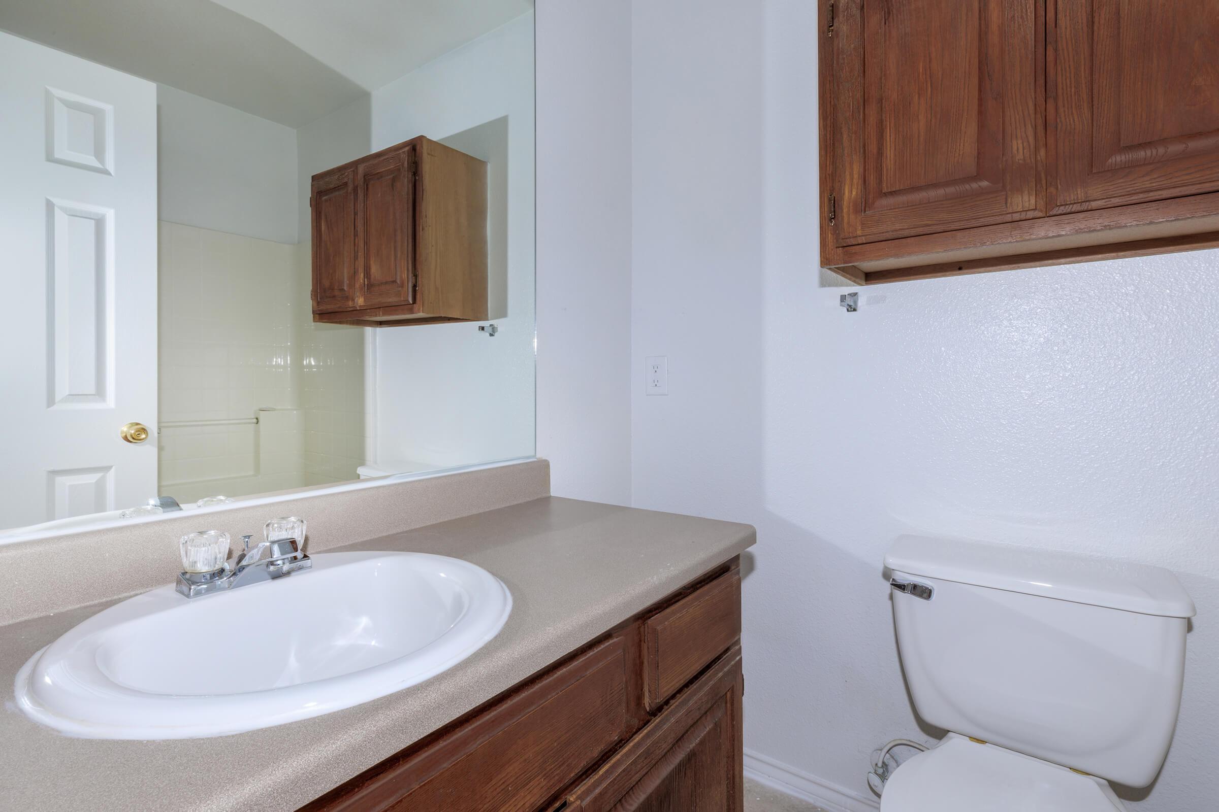 a kitchen with a sink and a mirror