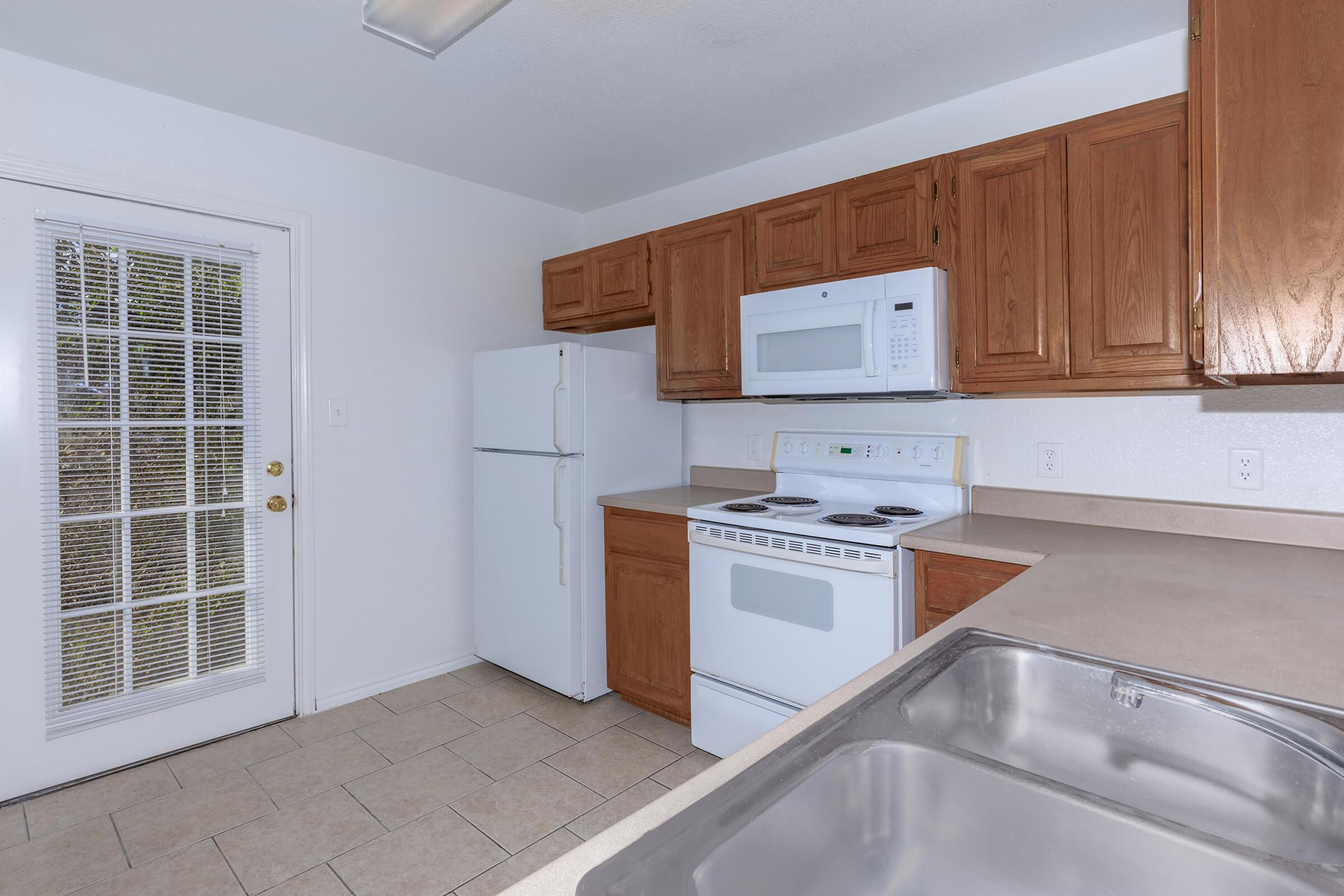 a kitchen with a refrigerator stove and microwave