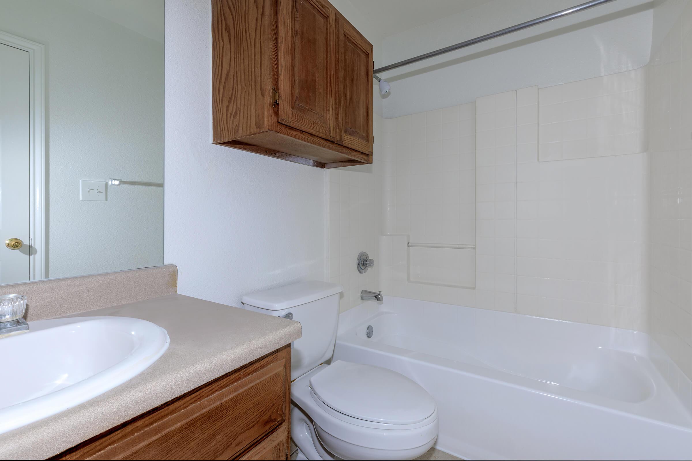 a white tub sitting next to a sink