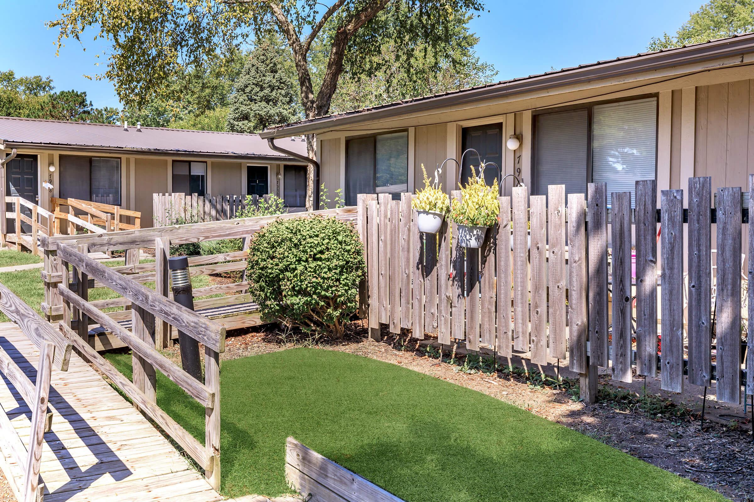 a group of lawn chairs sitting on top of a wooden fence