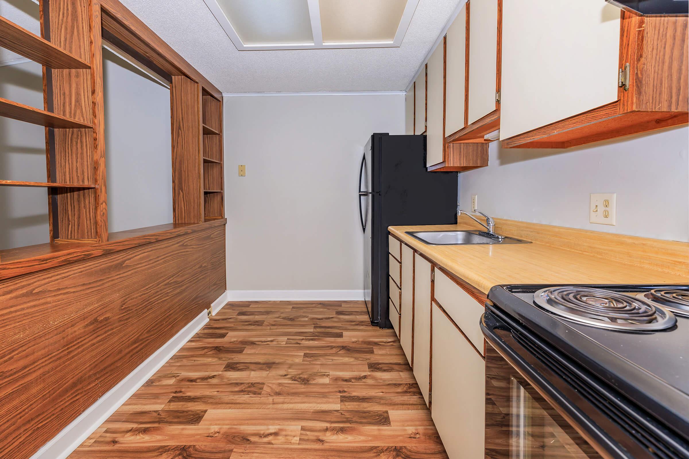 a kitchen with a stove top oven sitting inside of a building