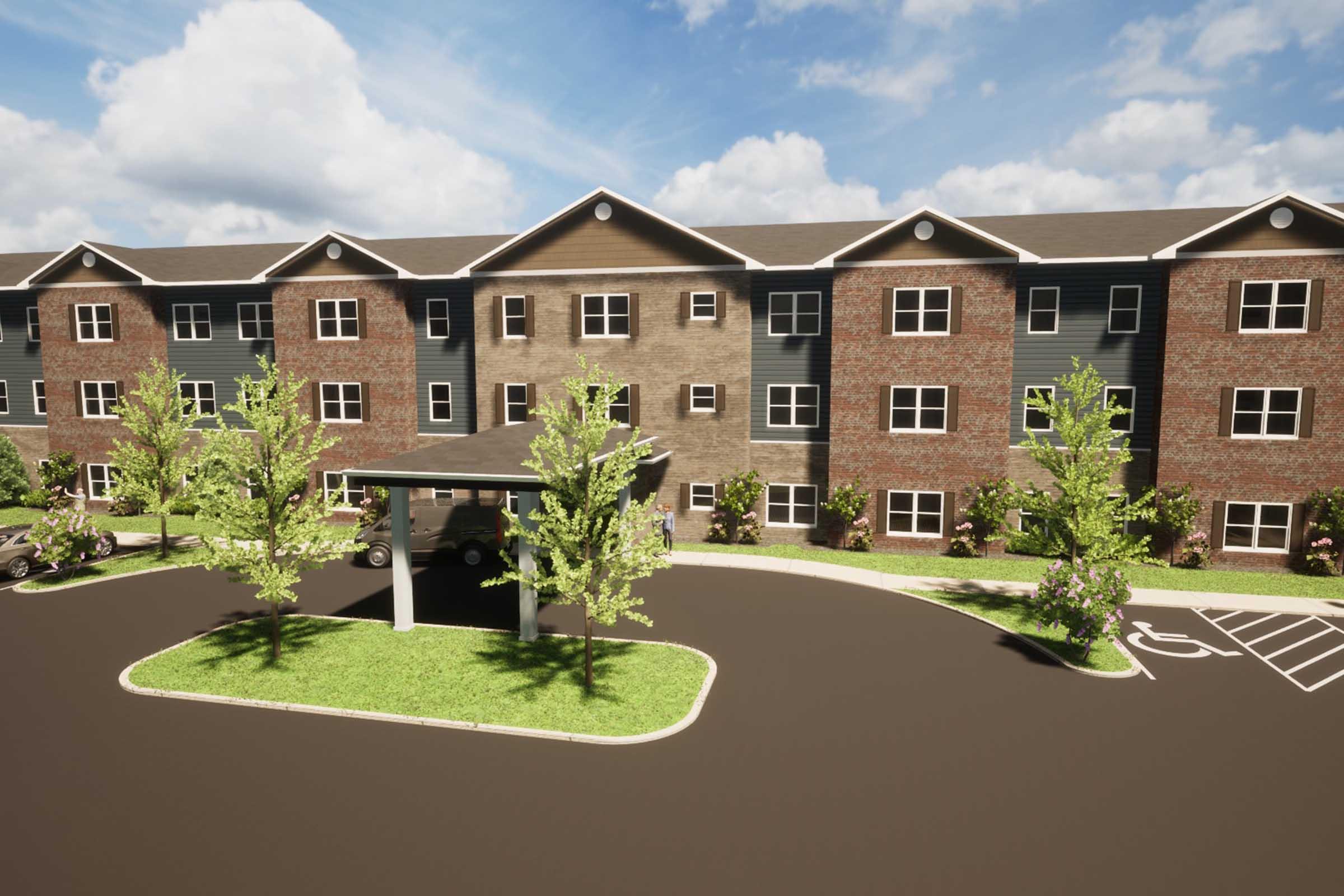 A modern multi-story residential building featuring a mix of brick and siding exteriors. The building is surrounded by well-maintained landscaping with trees and shrubs. A covered entrance is visible near the front, along with a paved parking area. The sky is bright with scattered clouds.