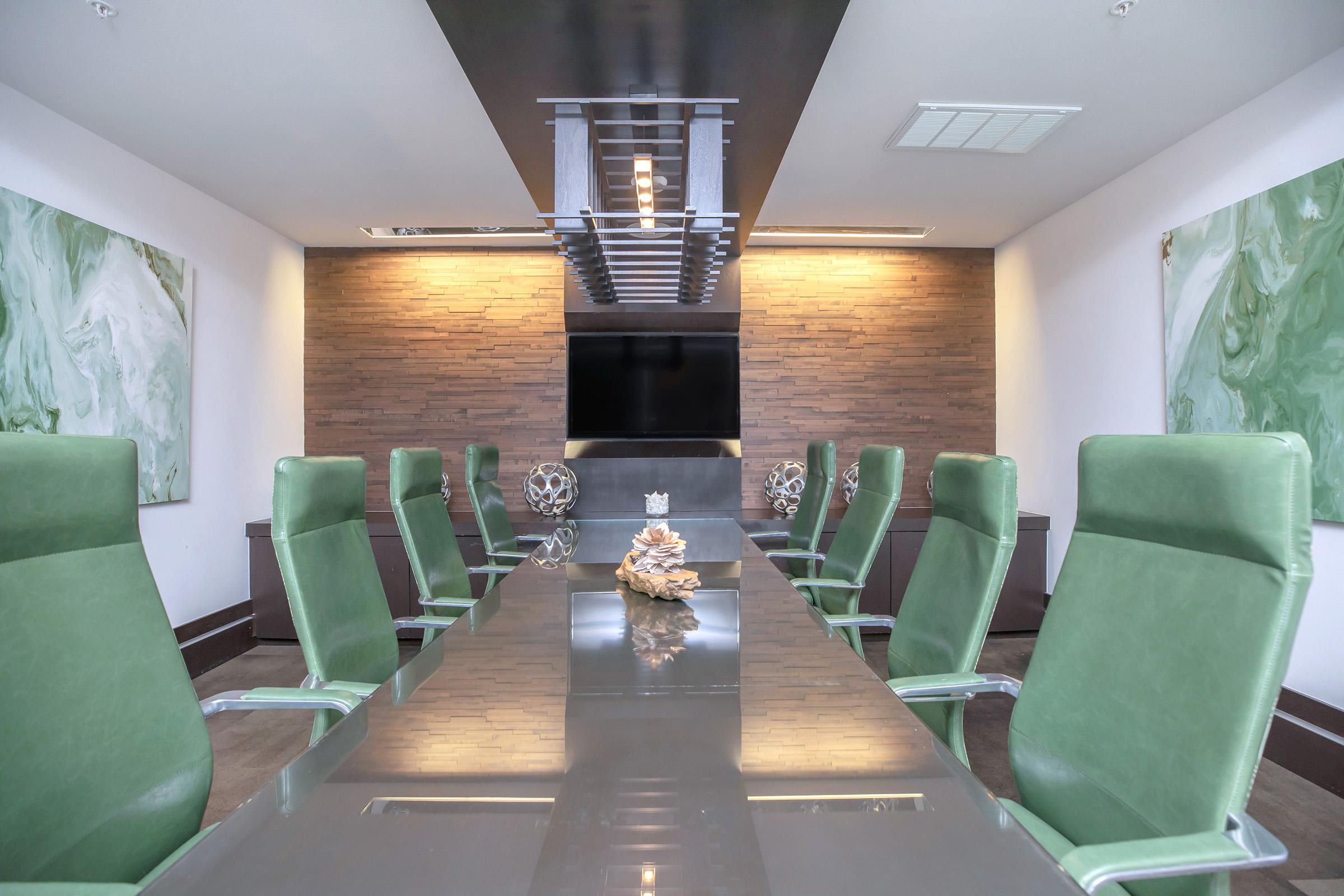 Modena business room with green office chairs 