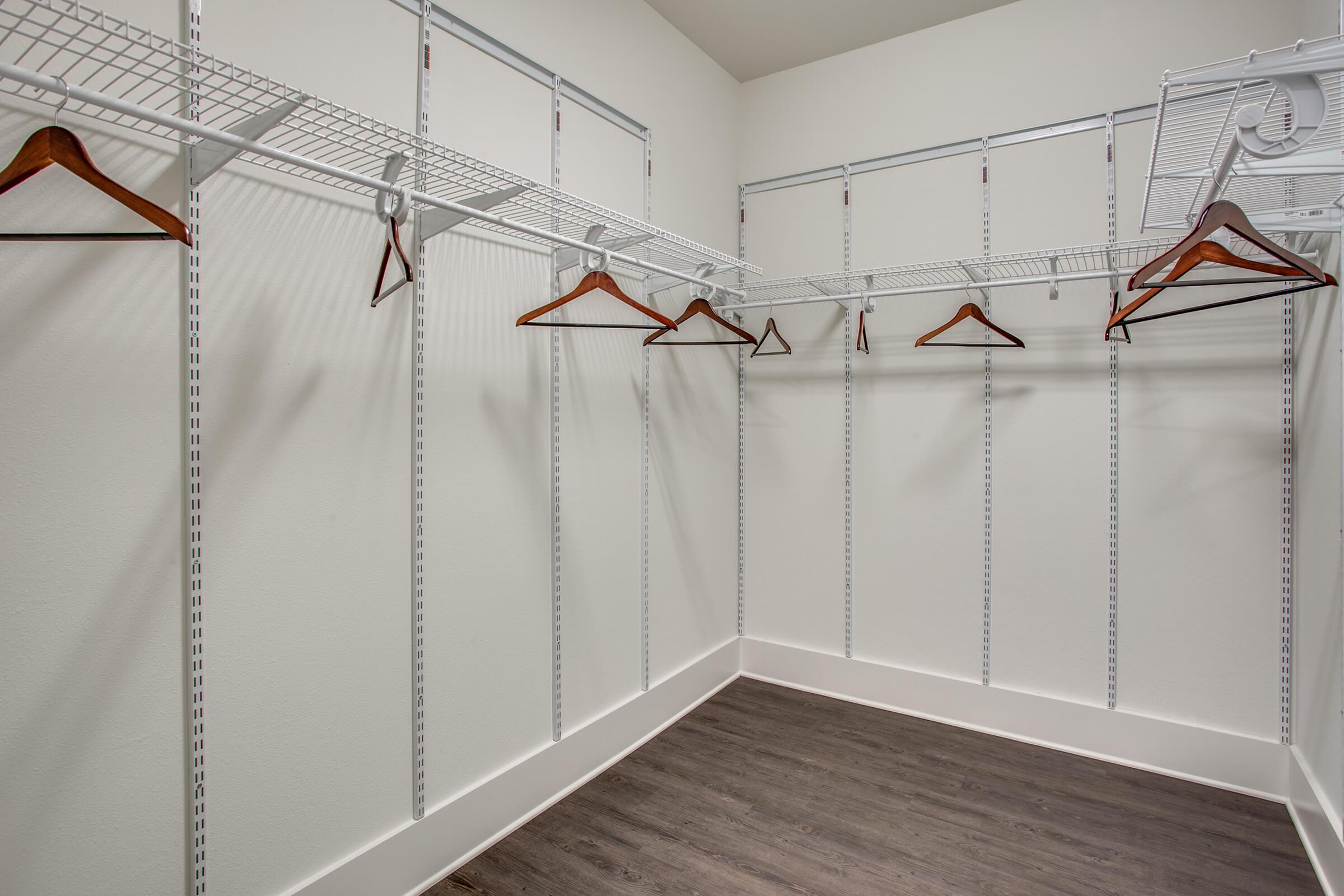 vacant walk-in closet with wooden floors