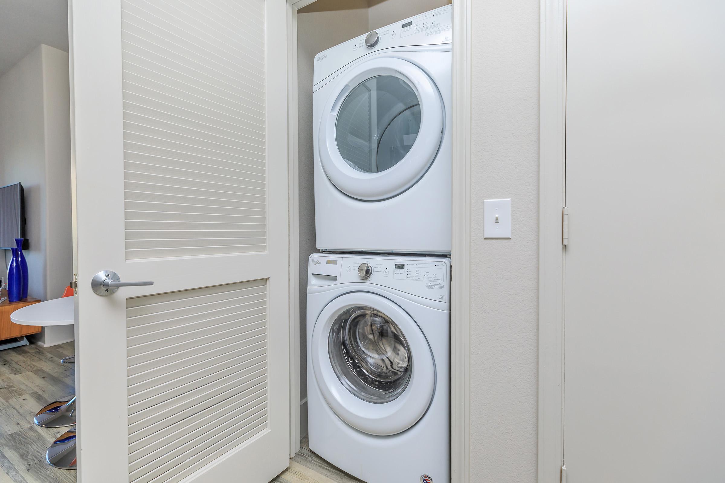 stacked washer and dryer in the laundry closet