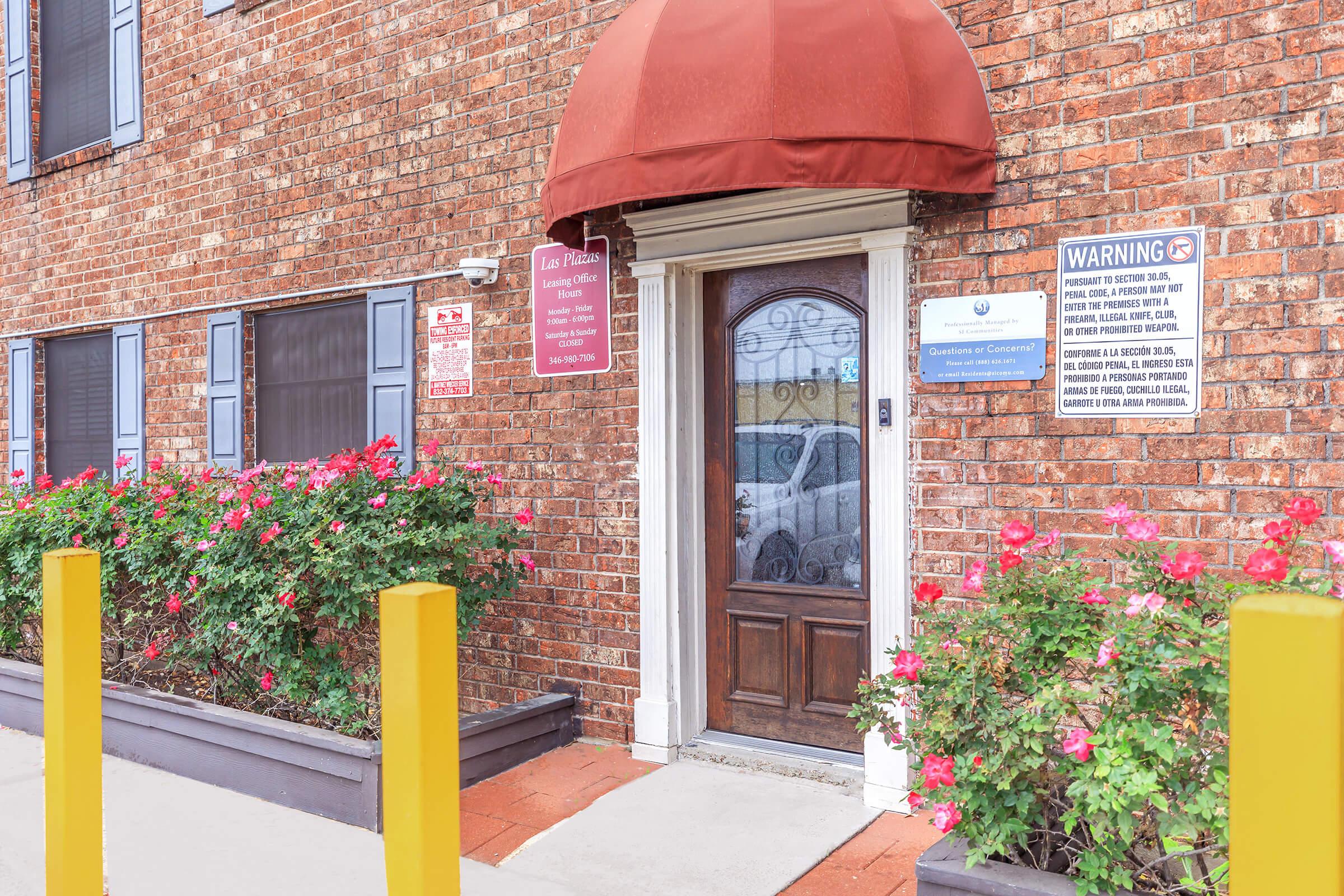 a sign in front of a brick building