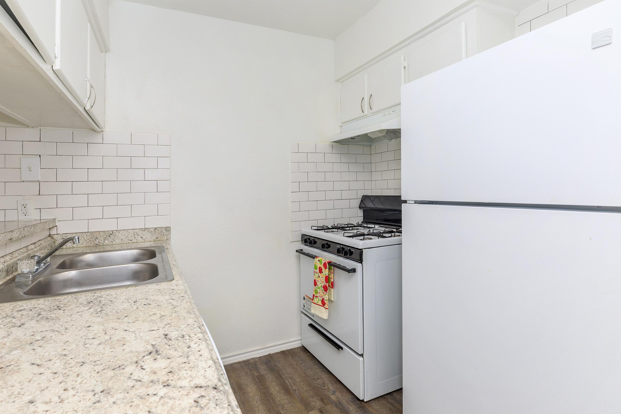 a white refrigerator freezer sitting inside of a kitchen