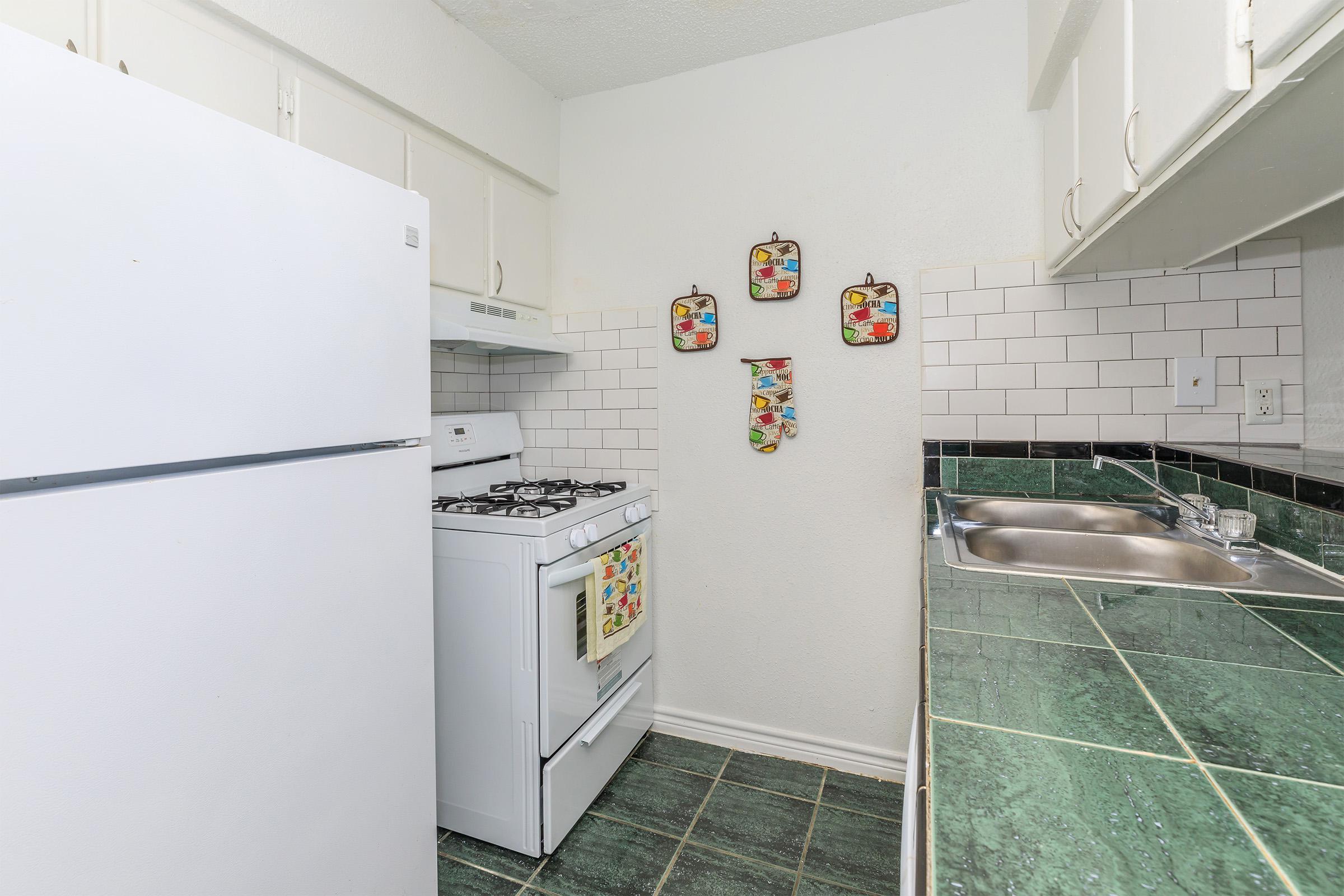 a white refrigerator freezer sitting inside of a kitchen