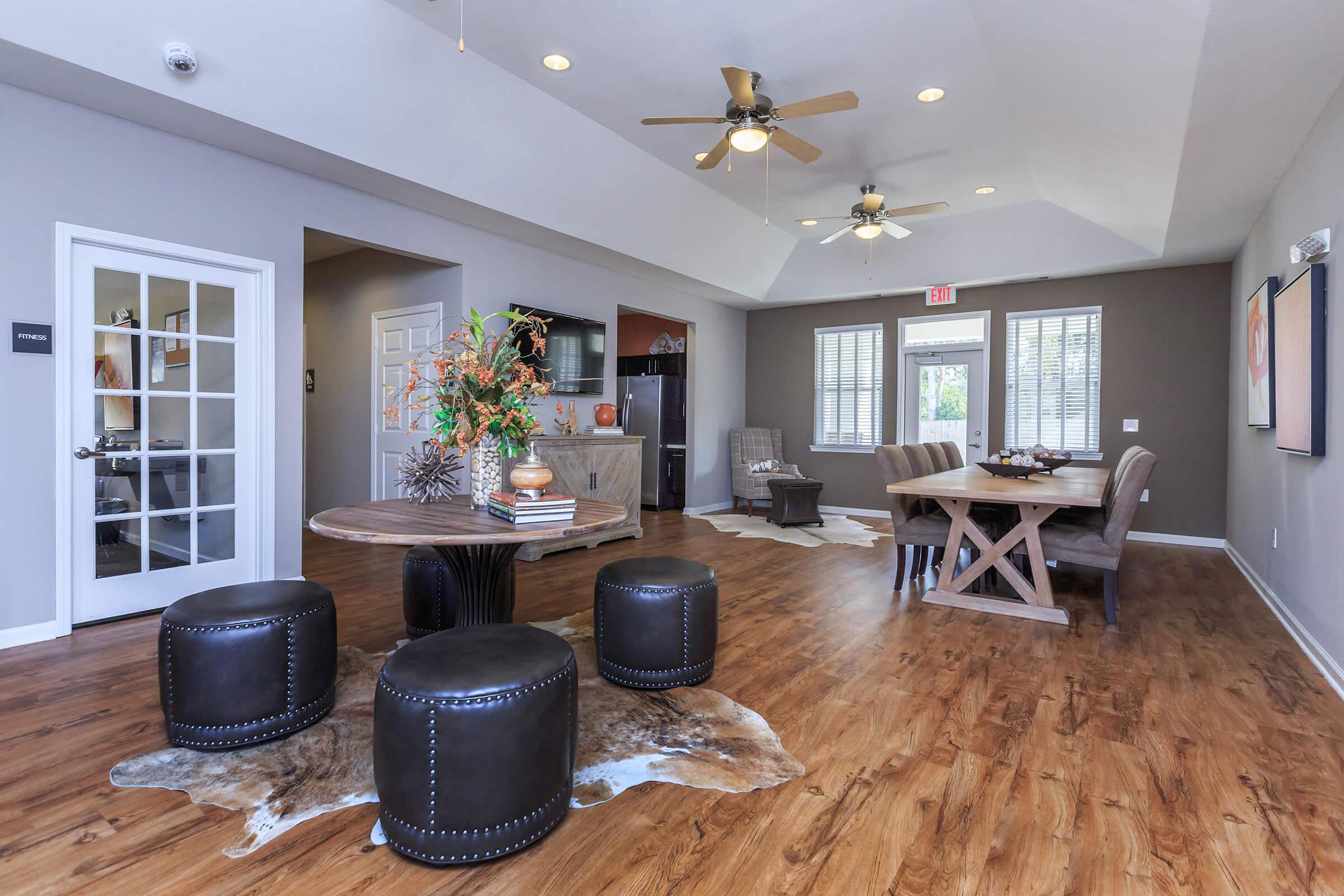 a living room filled with furniture on top of a hard wood floor